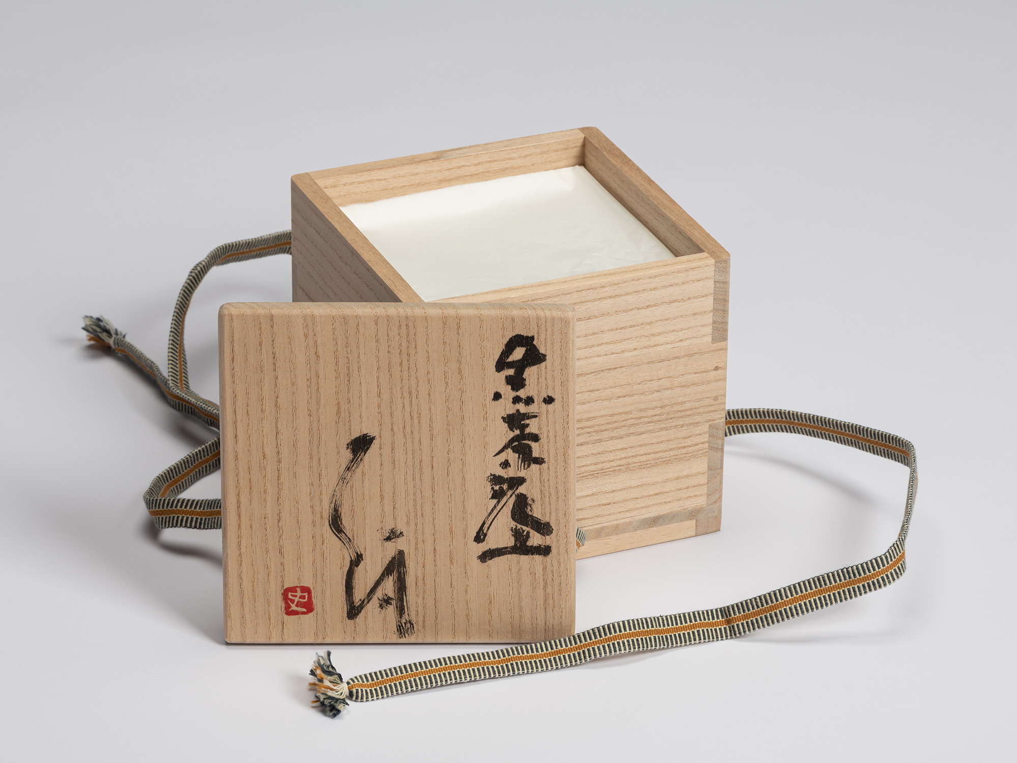 Signed wooden presentation box (tomobako) for Chawan No. 9 by Shiro Tsujimura, shown with the lid...