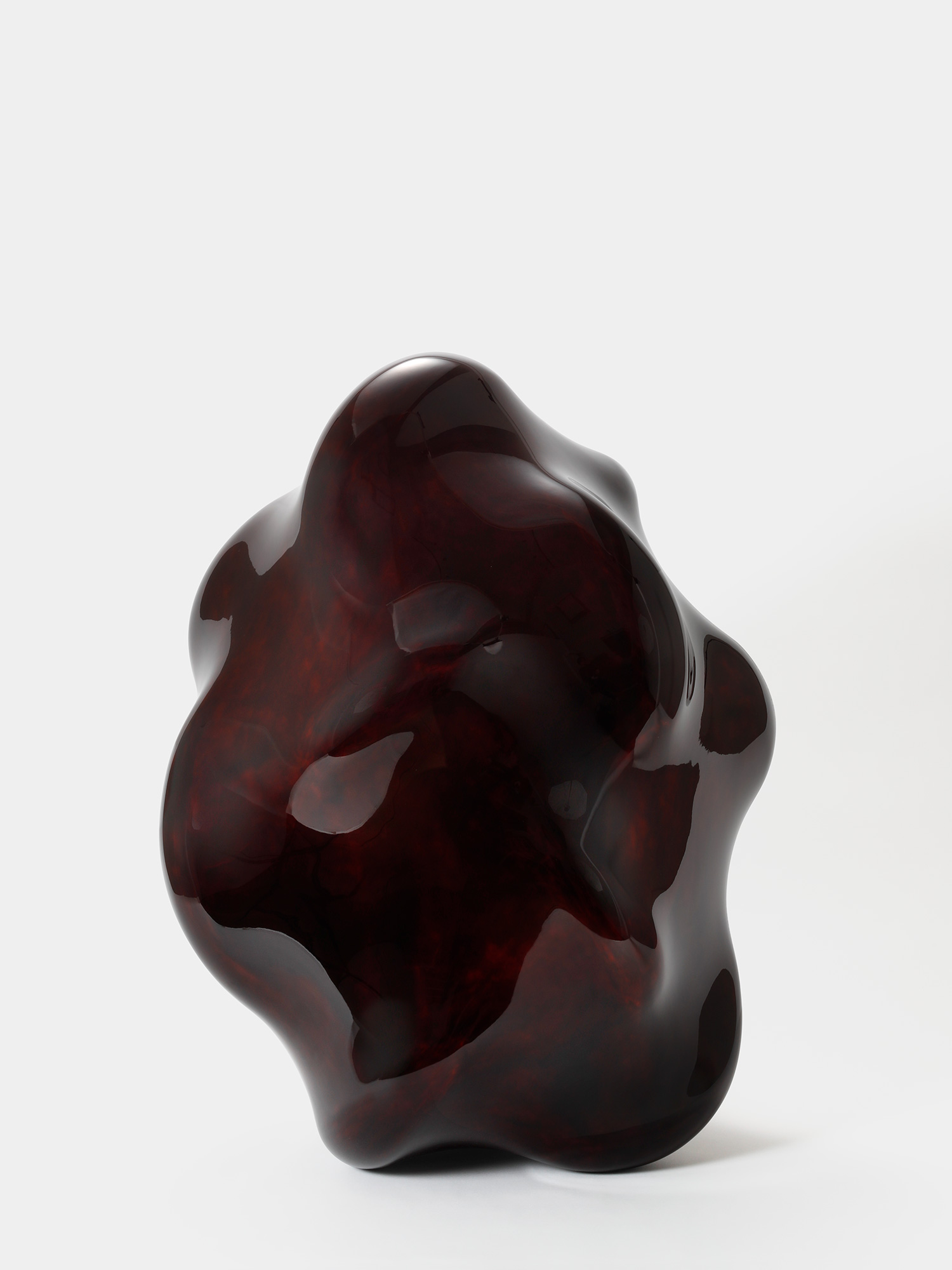 View of Taxis Groove – Wavy Line by Genta Ishizuka, an organic dark lacquer sculpture with a highly...