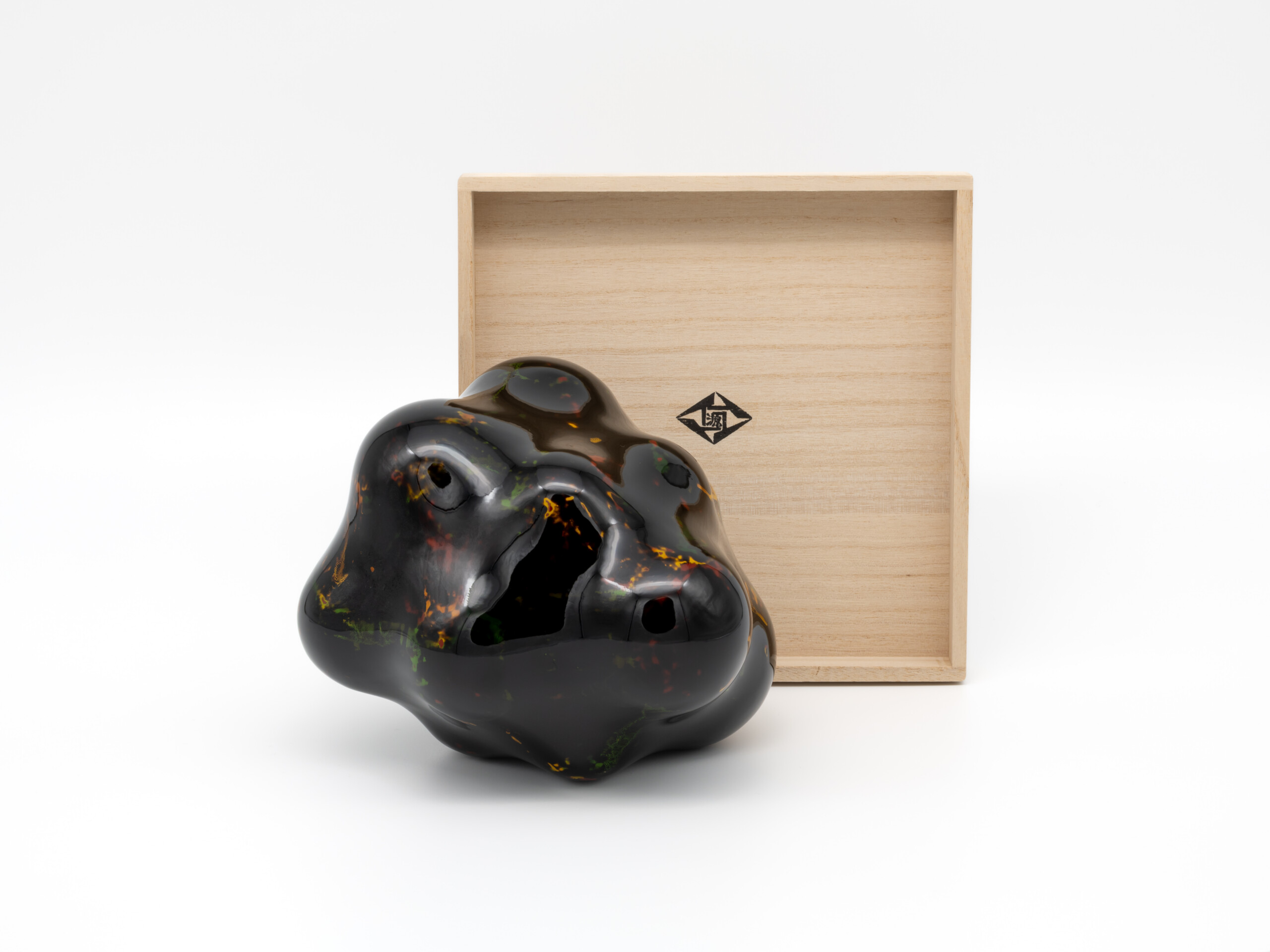 Untitled by Genta Ishizuka displayed beside its open paulownia wood presentation box (tomobako)....