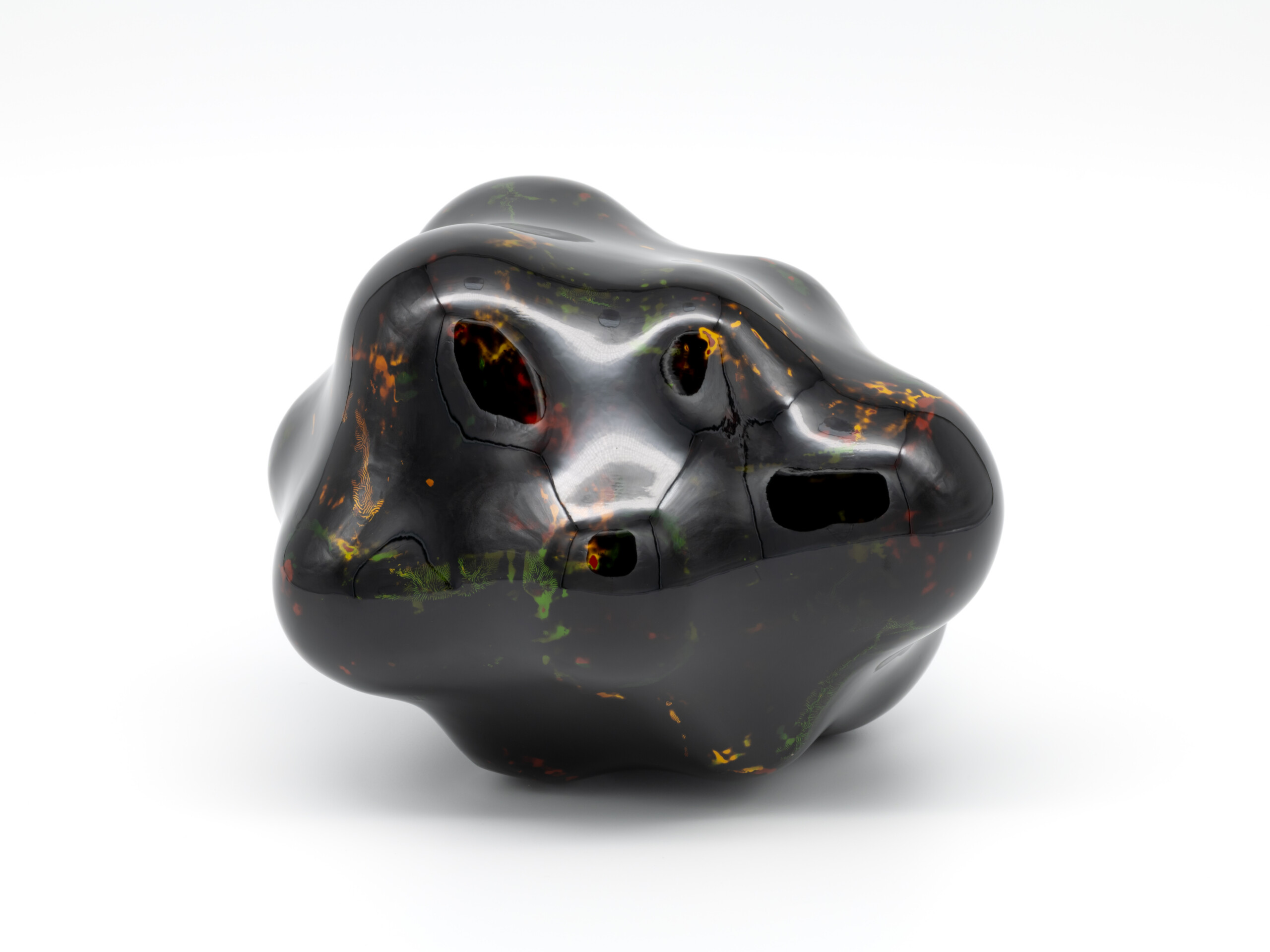 View of Untitled by Genta Ishizuka, an organic dark lacquer sculpture with a highly polished surface....