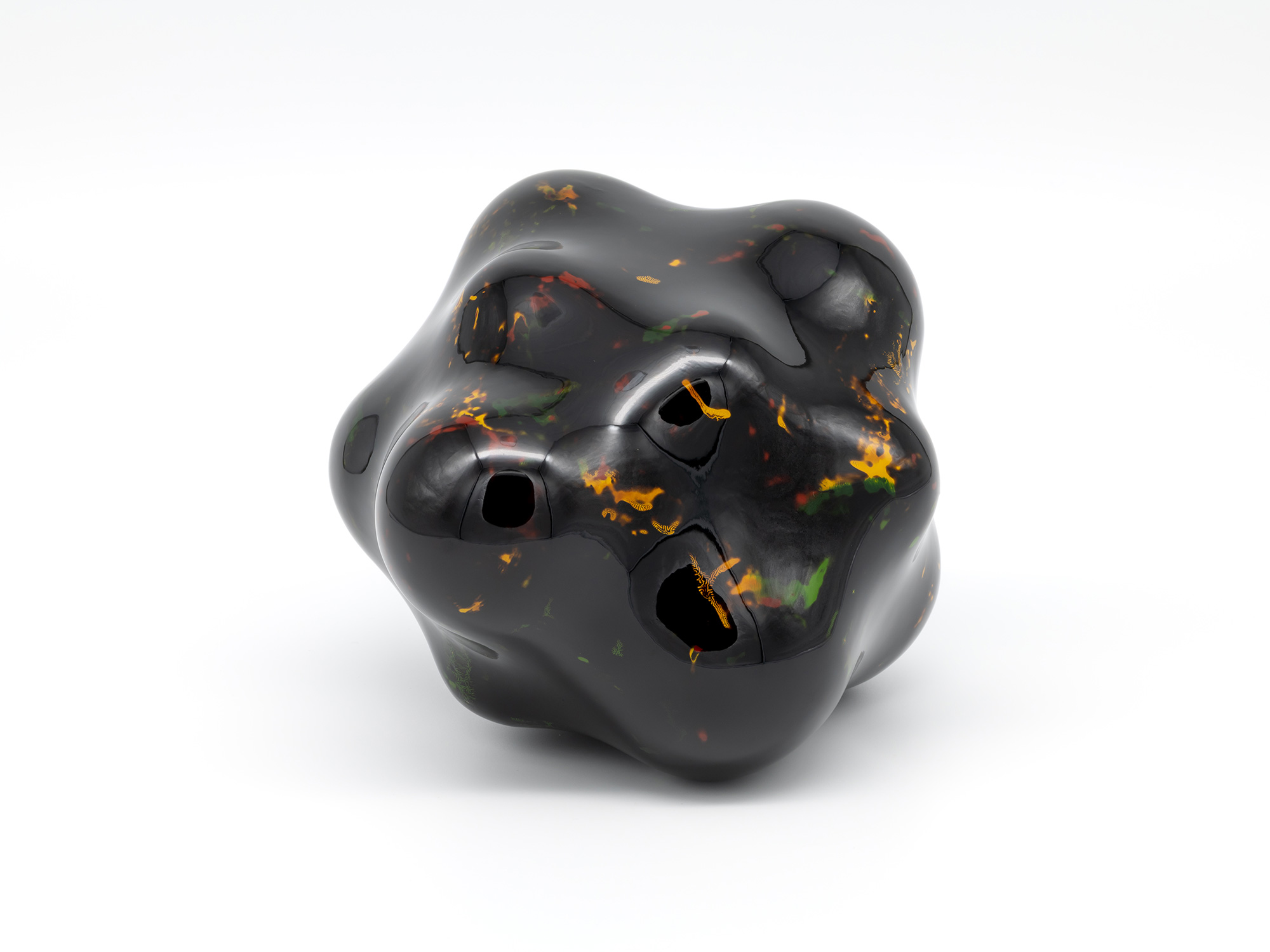 View of Untitled by Genta Ishizuka, an organic dark lacquer sculpture with a highly polished surface....