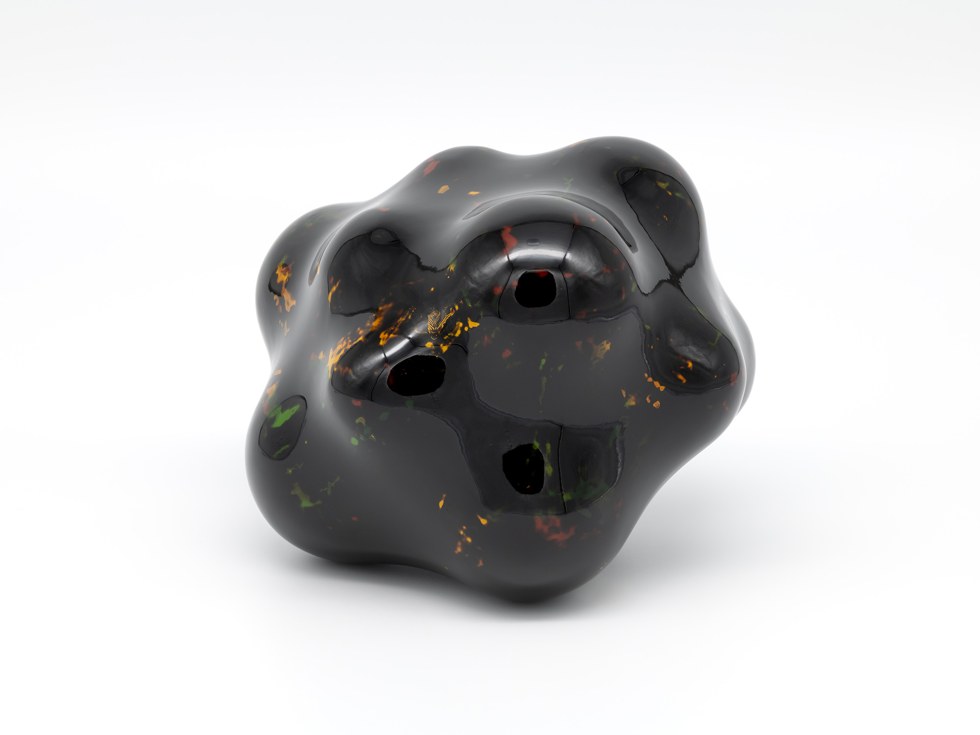 View of Untitled by Genta Ishizuka, an organic dark lacquer sculpture with a highly polished surface....