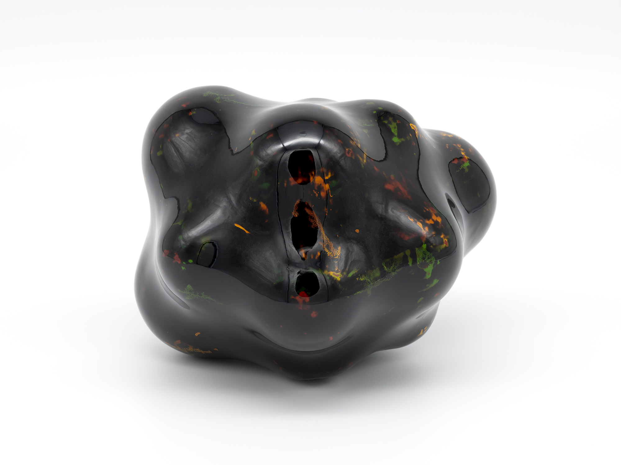 View of Untitled by Genta Ishizuka, an organic dark lacquer sculpture with a highly polished surface....