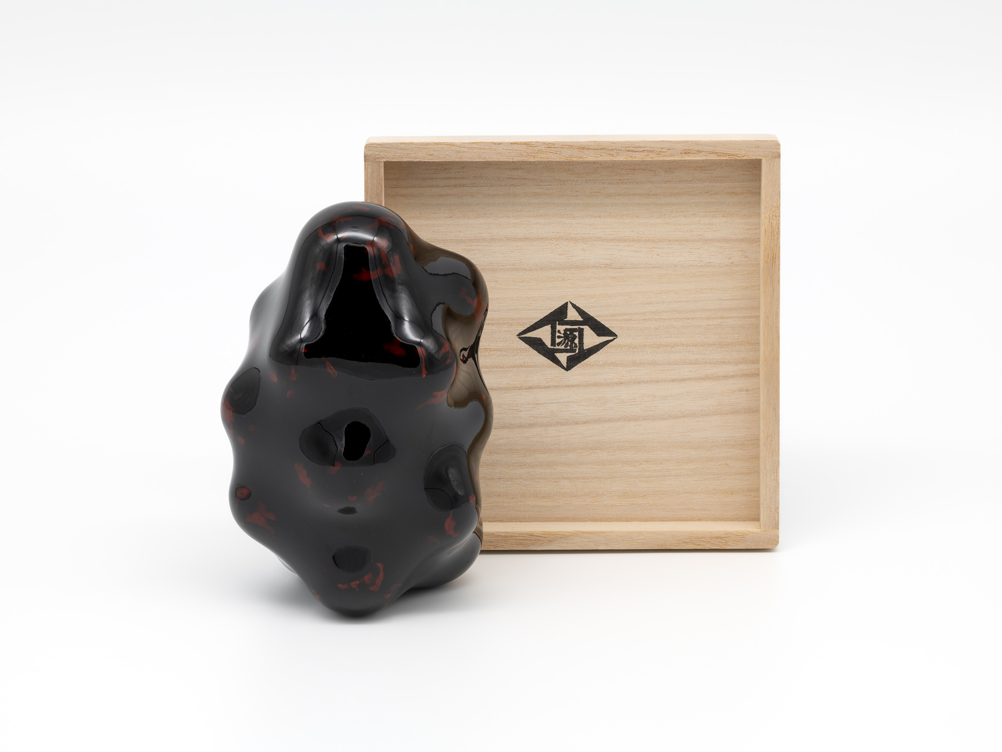 Untitled by Genta Ishizuka displayed beside its open paulownia wood presentation box (tomobako)....