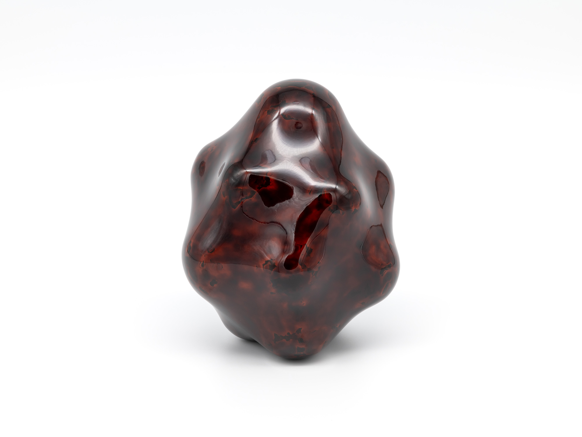 View of Untitled by Genta Ishizuka, an organic dark lacquer sculpture with a highly polished surface....