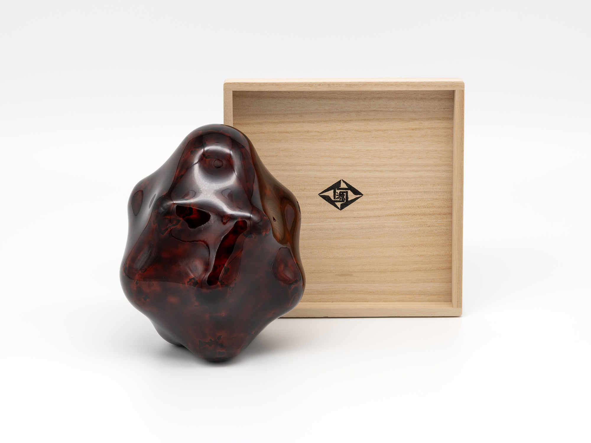 Untitled by Genta Ishizuka displayed beside its open paulownia wood presentation box (tomobako)....