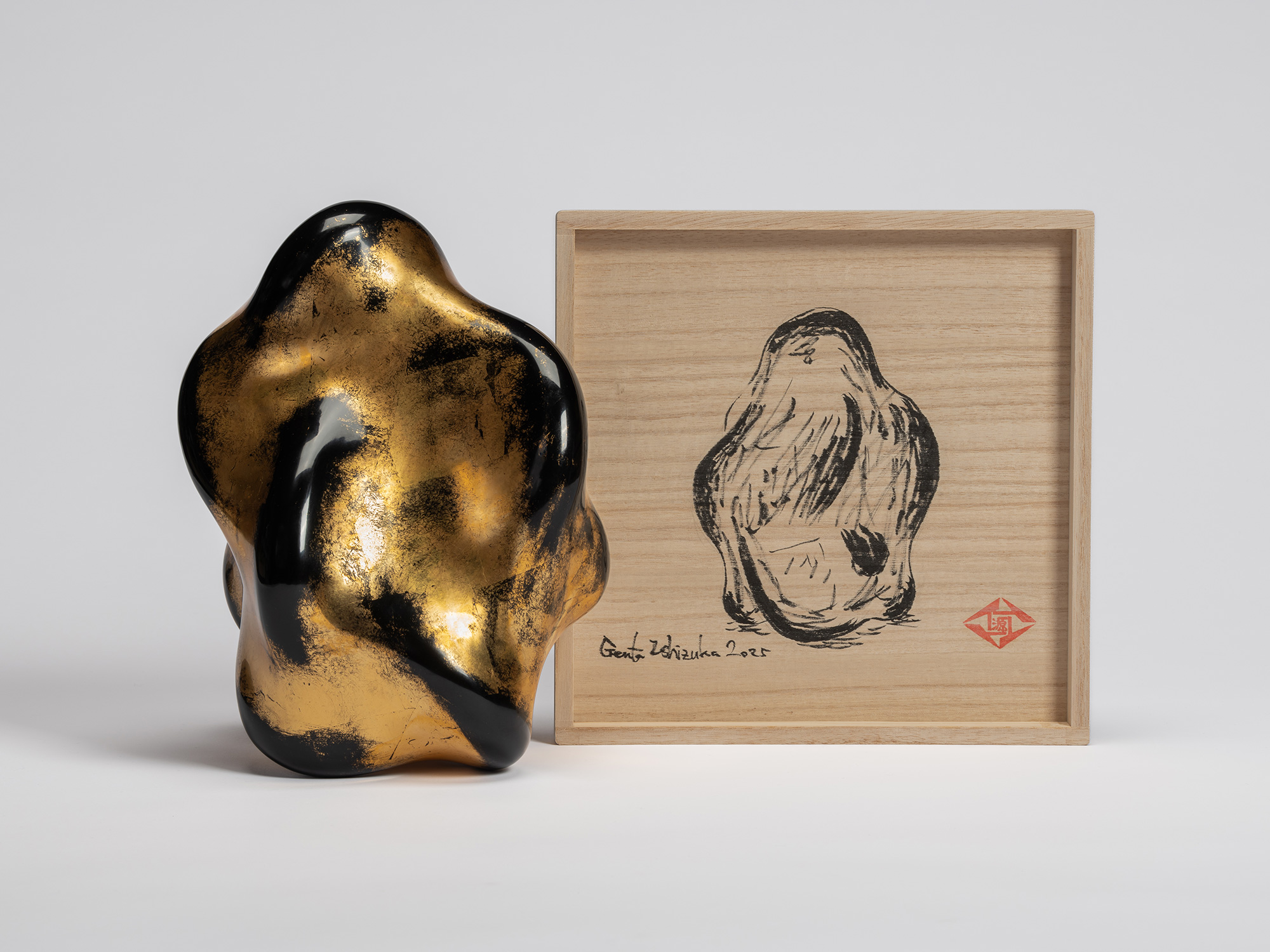 Untitled (Faded Gold) by Genta Ishizuka displayed beside its open paulownia wood presentation box...