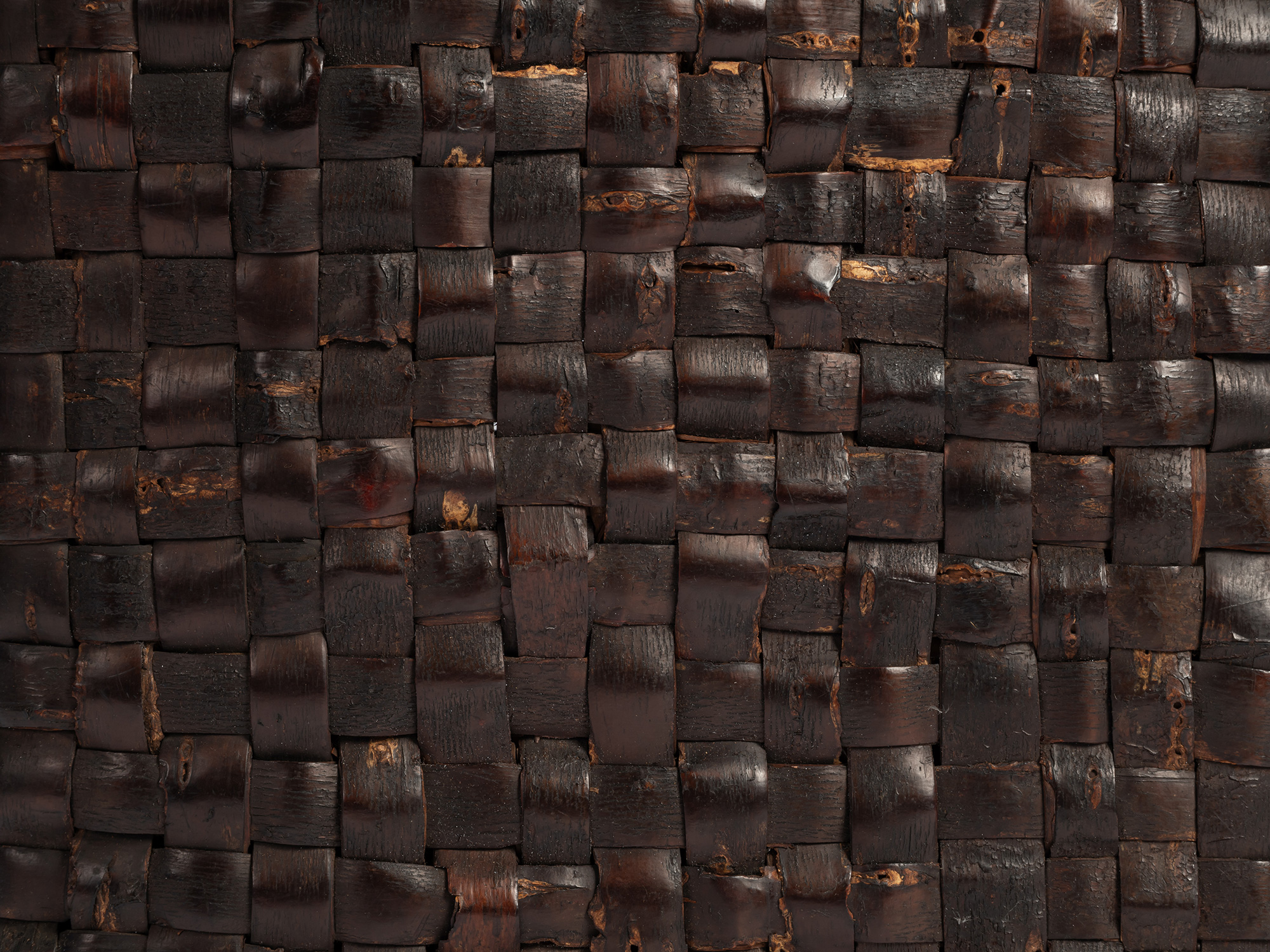 Close-up of the kabakago basket’s tightly woven surface, showing broad strips of dark brown wild...