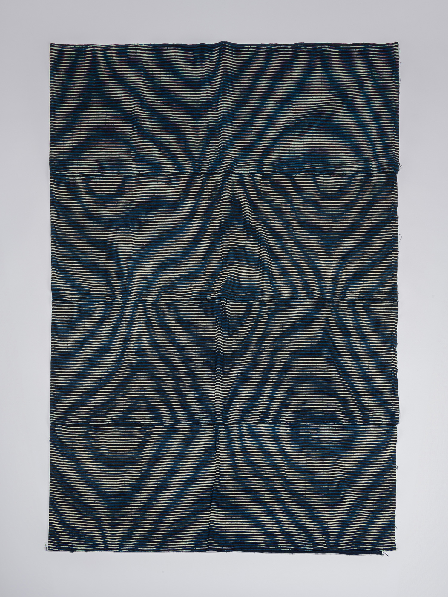 Full view of a rectangular kumanozome futon cover composed of joined textile panels, with fine...