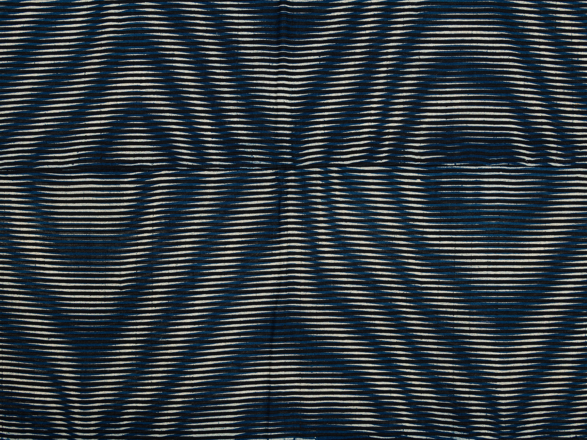 Detail of a kumanozome futon cover showing closely spaced indigo-dyed horizontal lines forming...