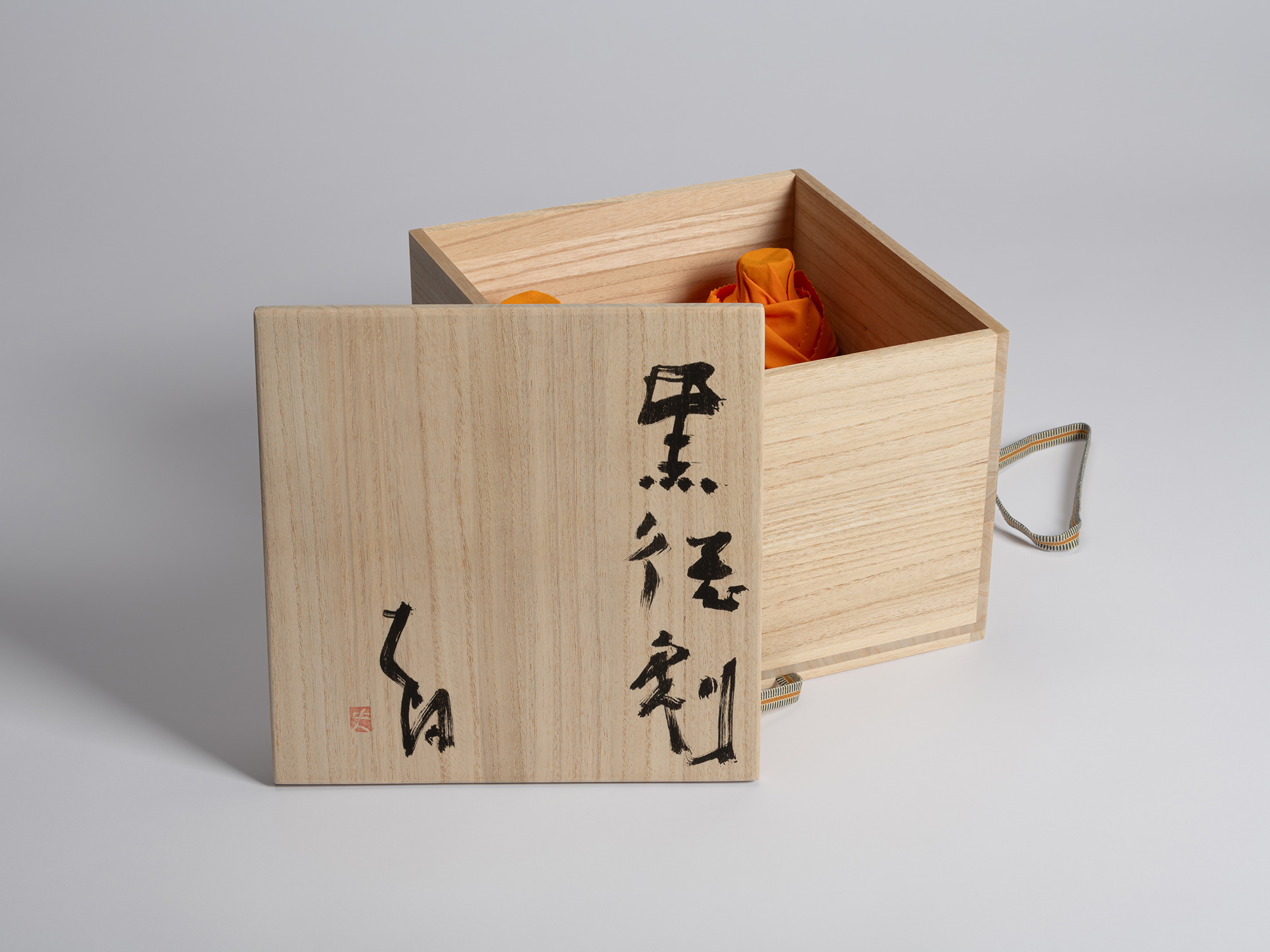 Open wooden tomobako designed to house multiple Kuro Tokkuri by Shiro Tsujimura, with black Japanese...