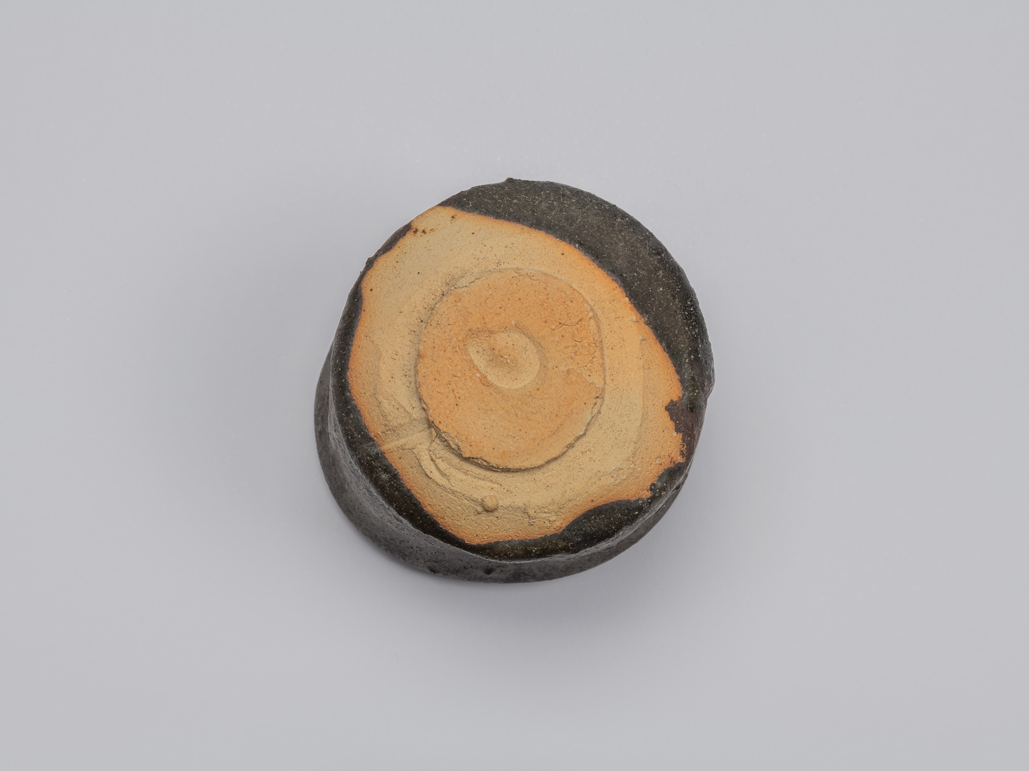 Underside of Kuro Guinomi by Shiro Tsujimura, showing a circular foot and broad area of exposed...