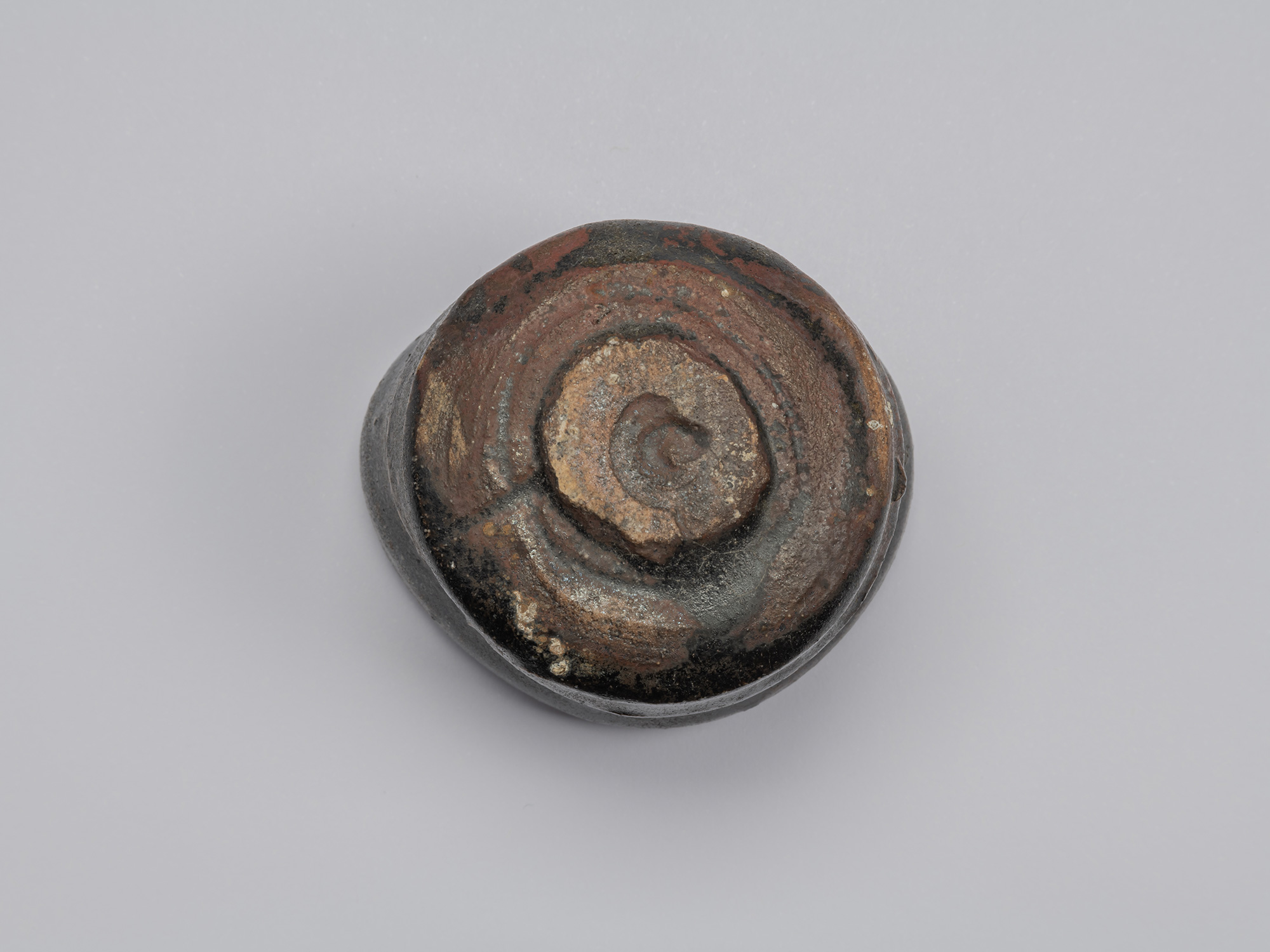 Kuro Guinomi by Shiro Tsujimura, underside view, showing an irregular circular foot surrounded...