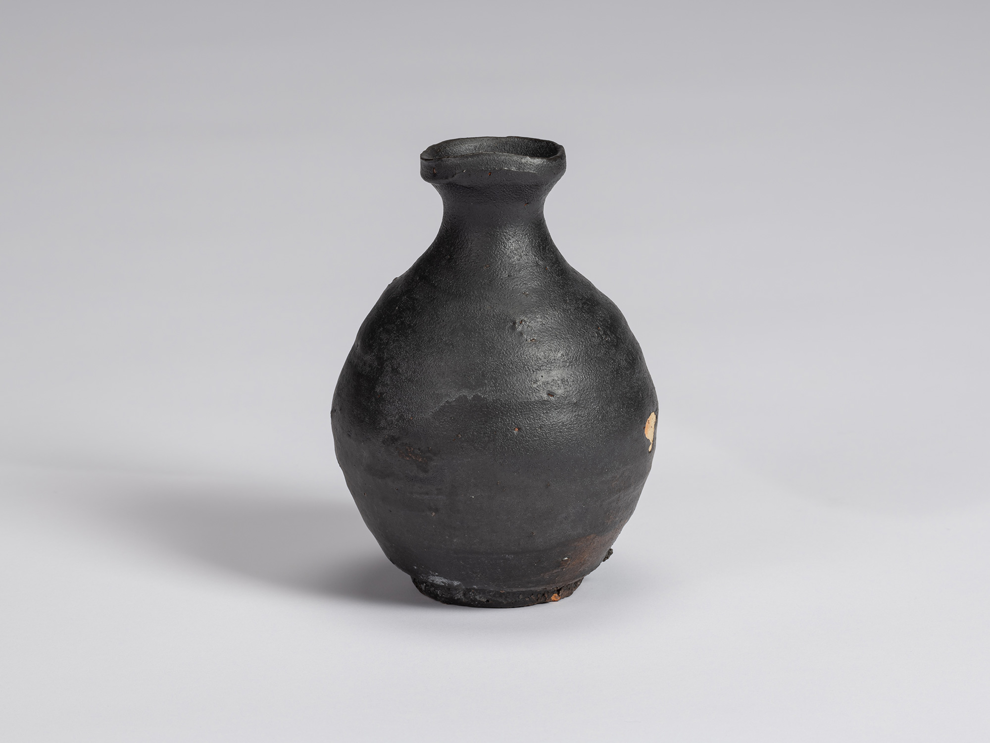 Alternate view of Shiro Tsujimura’s Kuro Tokkuri, showing its rounded form, subtly lustrous black...