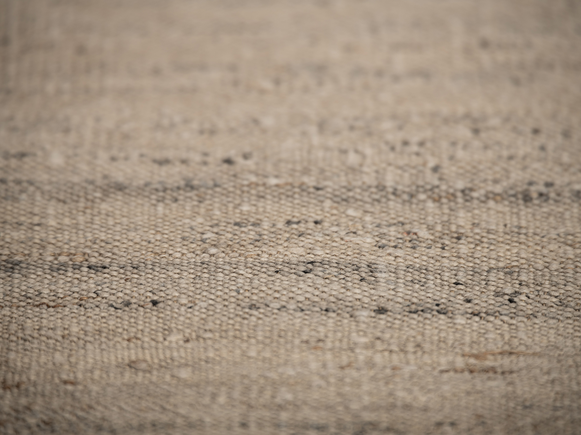 Detail view of otsuzure fabric highlighting the uneven thickness of the handwoven fibers and irregular...