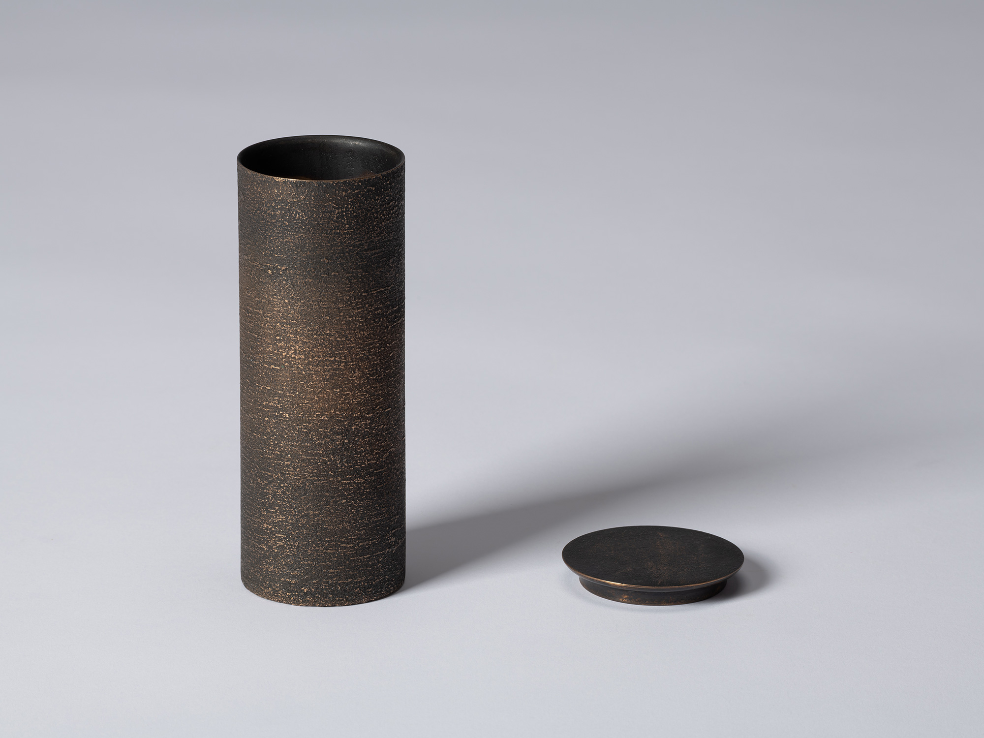 bronze as Bronze II No. 14 by Koji Hatakeyama shown with its circular lid removed, revealing the...