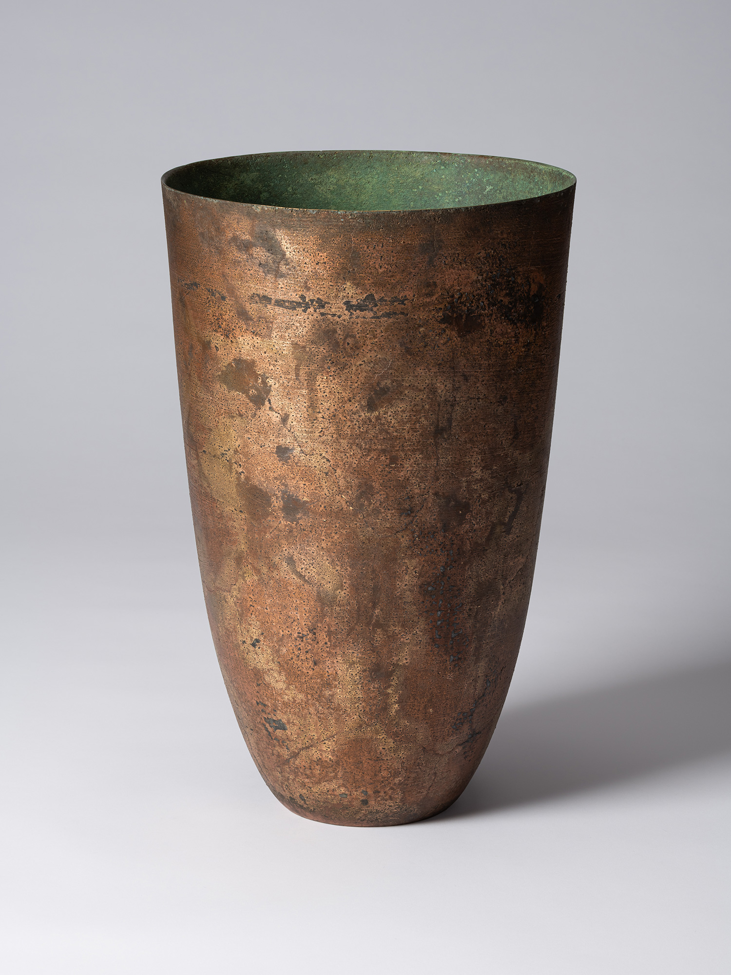 Front view of Koji Hatakeyama’s bronze as Bronze II No. 1, a tall, tapered bronze vessel with gently...