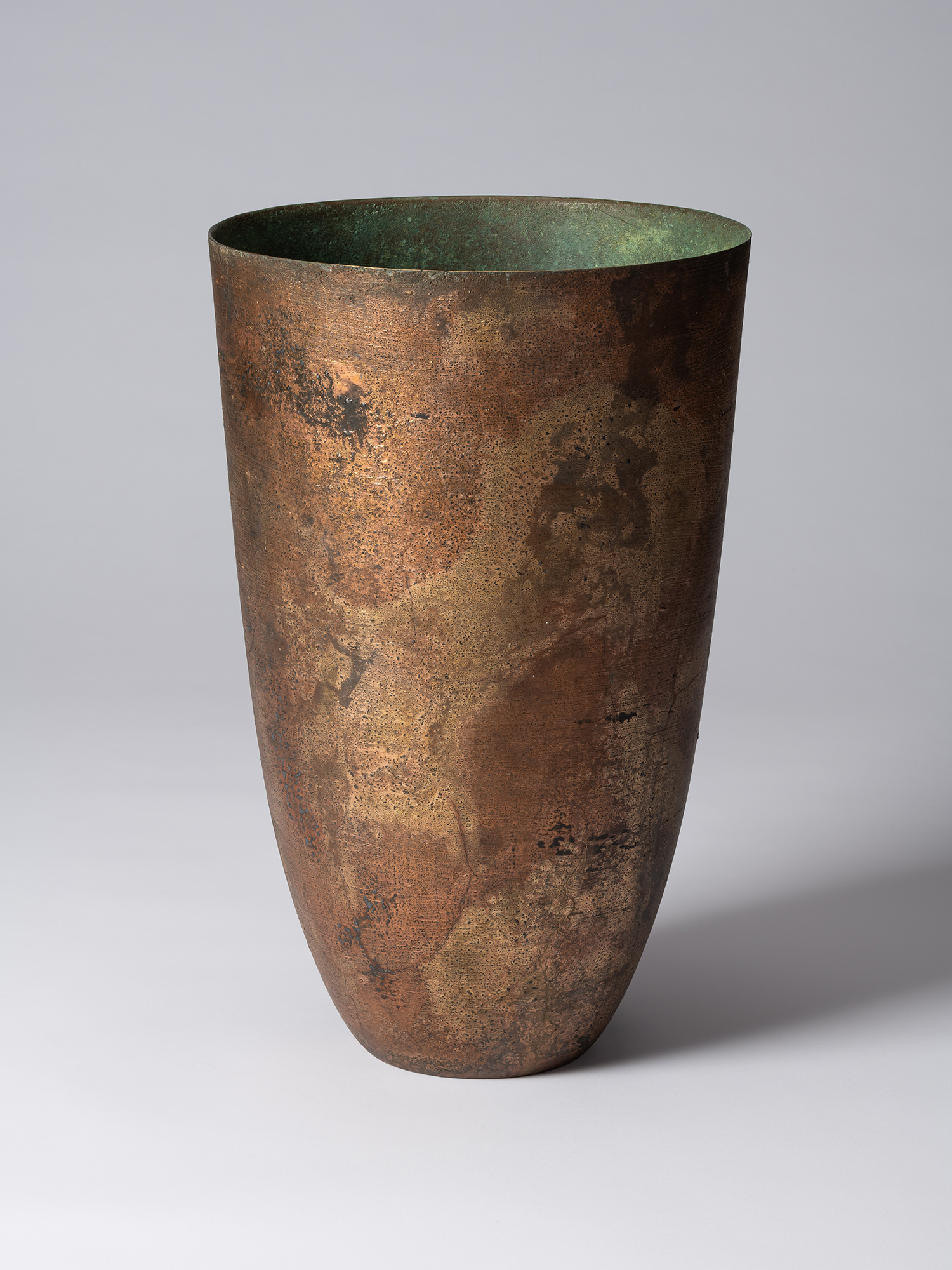 Front view of Koji Hatakeyama’s bronze as Bronze II No. 1, a tall, tapered bronze vessel with gently...