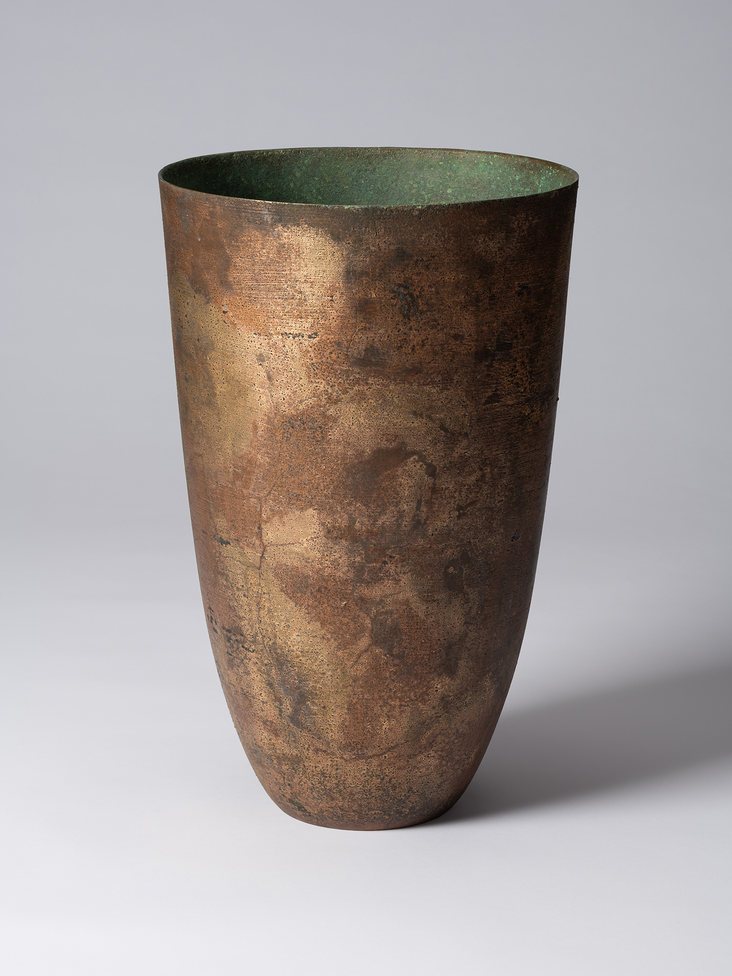 Front view of Koji Hatakeyama’s bronze as Bronze II No. 1, a tall, tapered bronze vessel with gently...