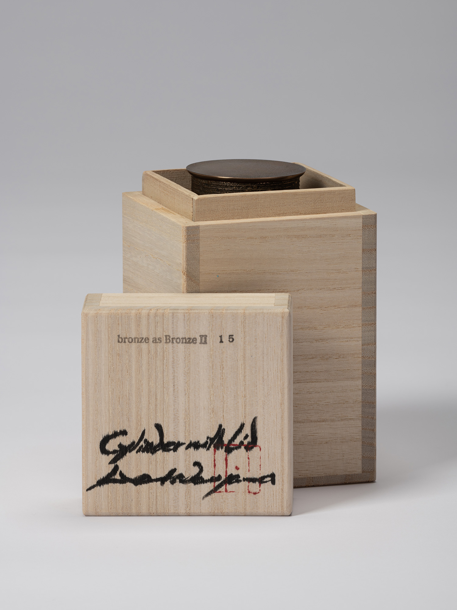 Koji Hatakeyama’s bronze as Bronze II No. 15 partially enclosed in its wooden tomobako, with the...