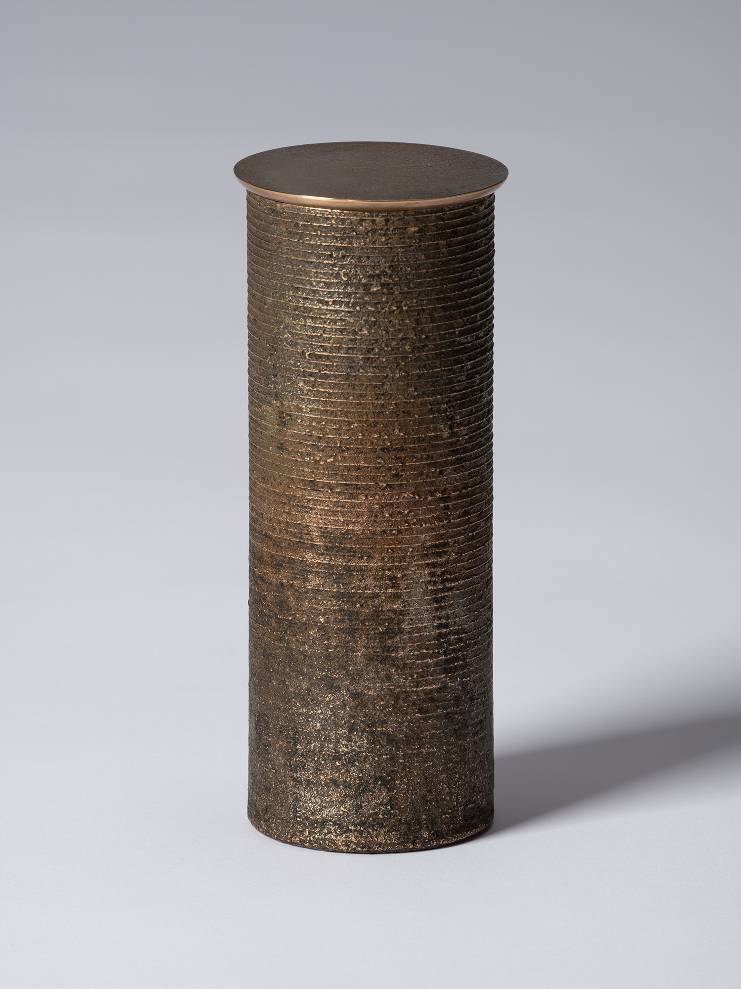 bronze as Bronze II No. 15 by Koji Hatakeyama, a tall cylindrical bronze vessel with a fitted circular...