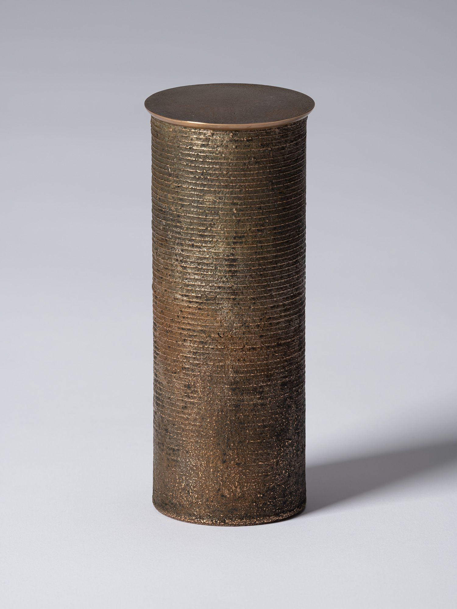bronze as Bronze II No. 15 by Koji Hatakeyama, a tall cylindrical bronze vessel with a fitted circular...