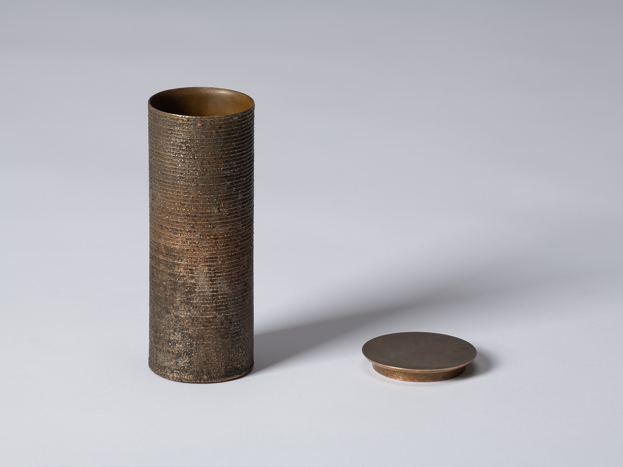 bronze as Bronze II No. 15 by Koji Hatakeyama shown with its circular lid removed, revealing the...