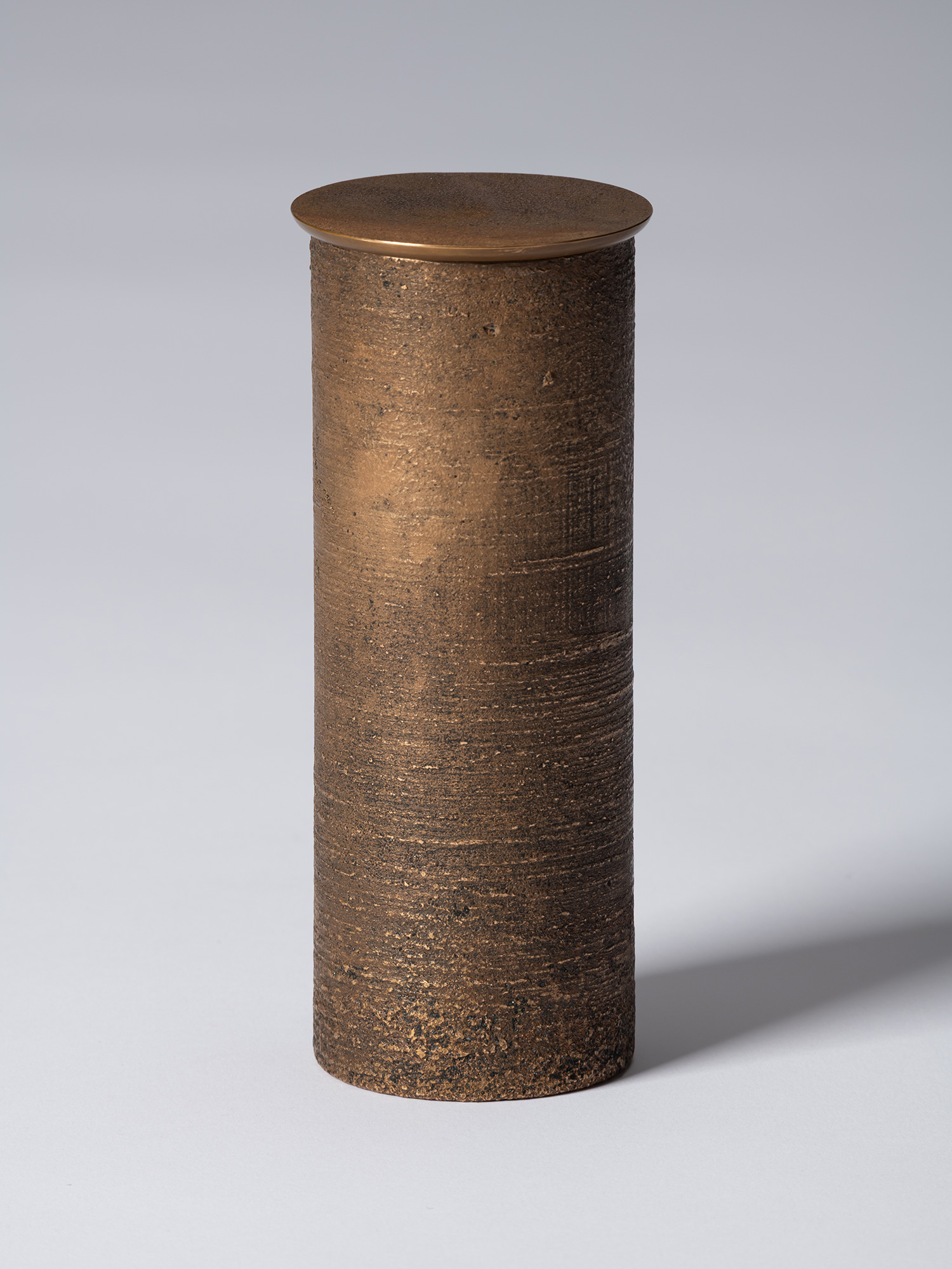 bronze as Bronze II No. 16 by Koji Hatakeyama, a tall cylindrical bronze vessel with a fitted circular...