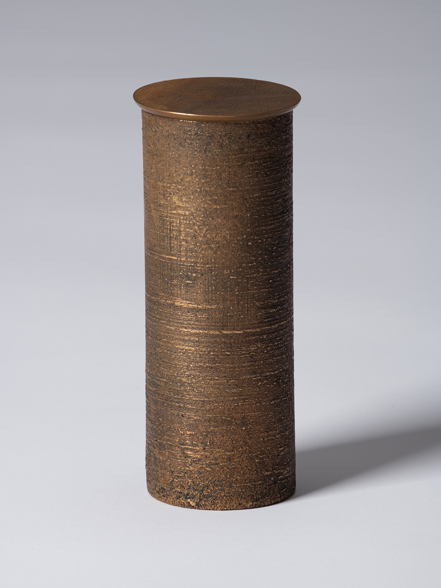 bronze as Bronze II No. 16 by Koji Hatakeyama, a tall cylindrical bronze vessel with a fitted circular...