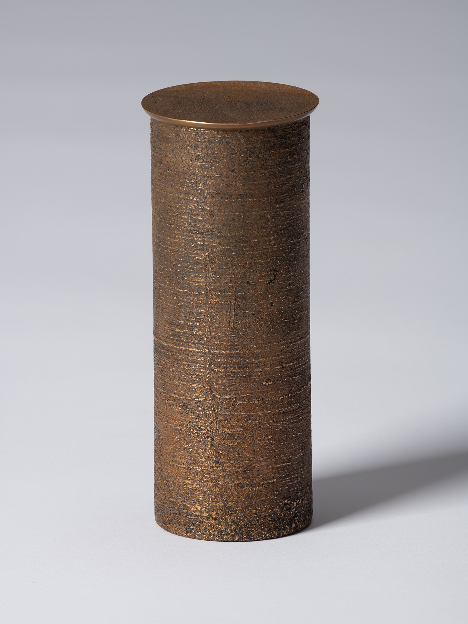 bronze as Bronze II No. 16 by Koji Hatakeyama, a tall cylindrical bronze vessel with a fitted circular...