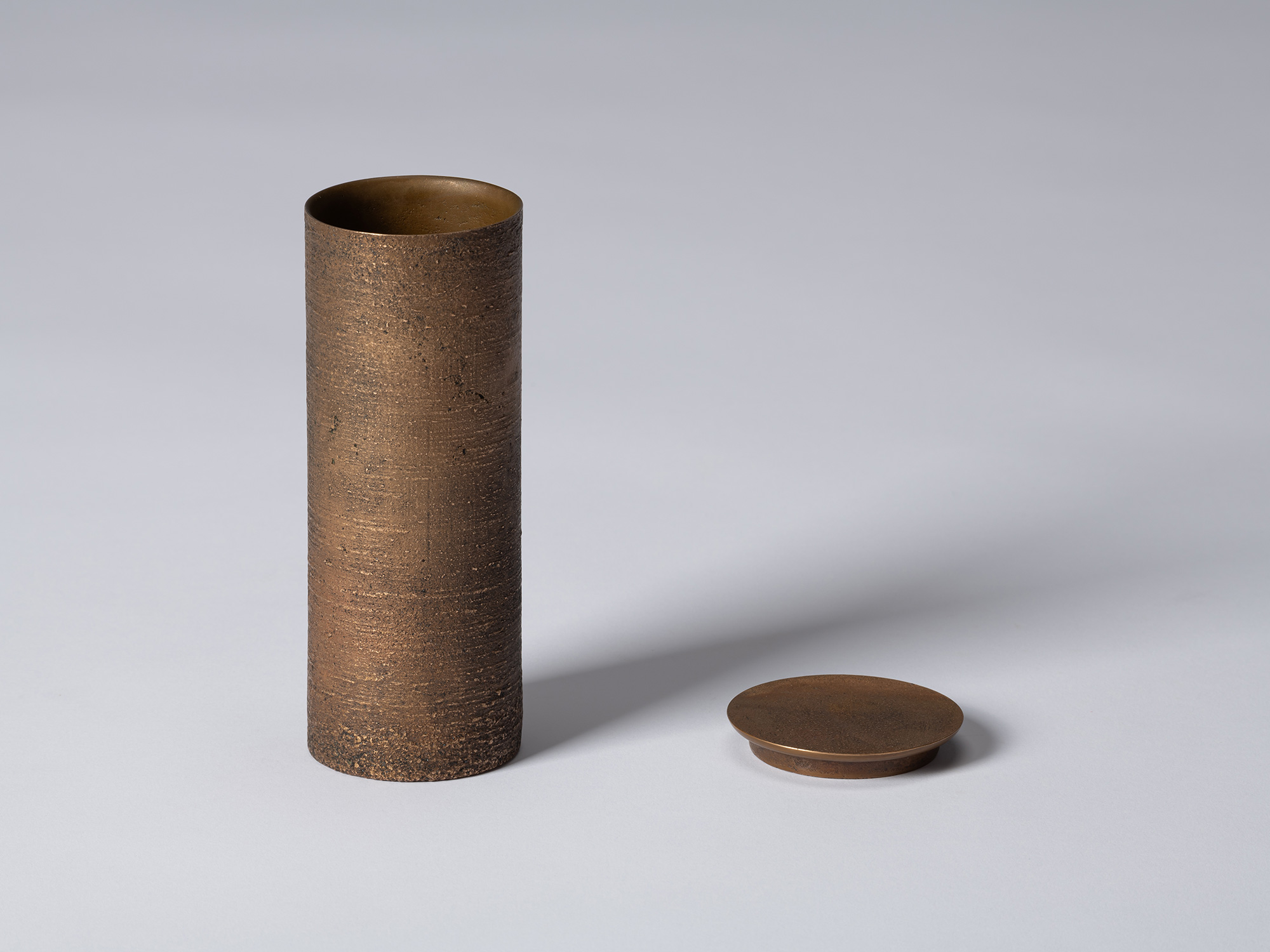 bronze as Bronze II No. 16 by Koji Hatakeyama shown with its circular lid removed, revealing the...
