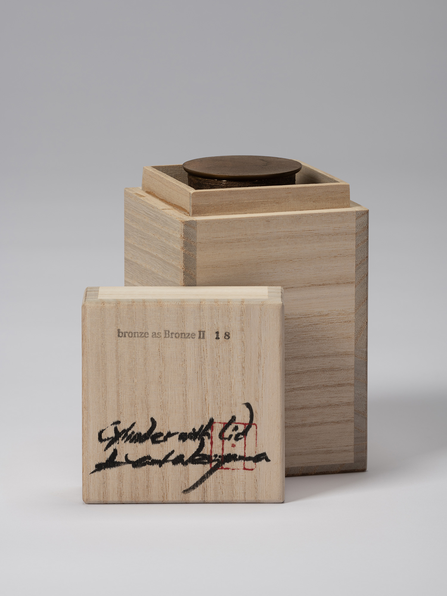 Koji Hatakeyama’s bronze as Bronze II No. 18 partially enclosed in its wooden tomobako, with the...