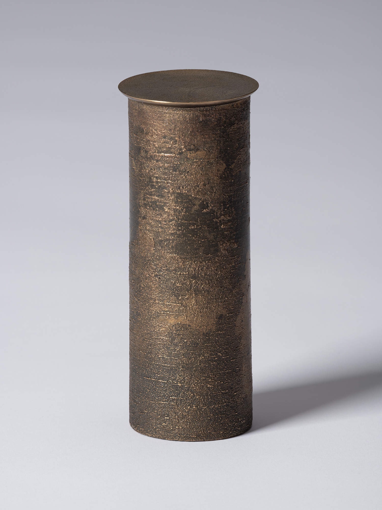 bronze as Bronze II No. 19 by Koji Hatakeyama, a tall cylindrical bronze vessel with a fitted circular...