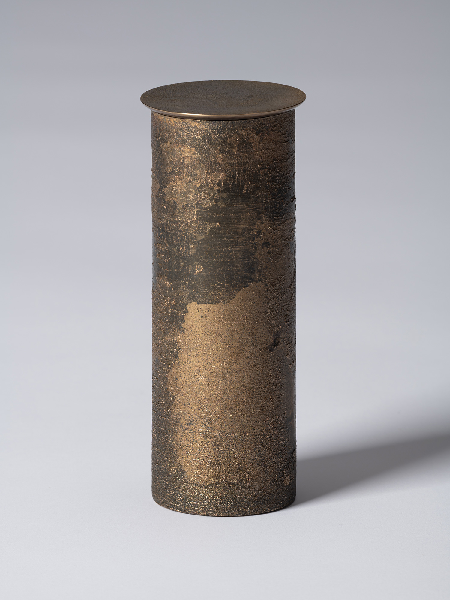bronze as Bronze II No. 19 by Koji Hatakeyama, a tall cylindrical bronze vessel with a fitted circular...