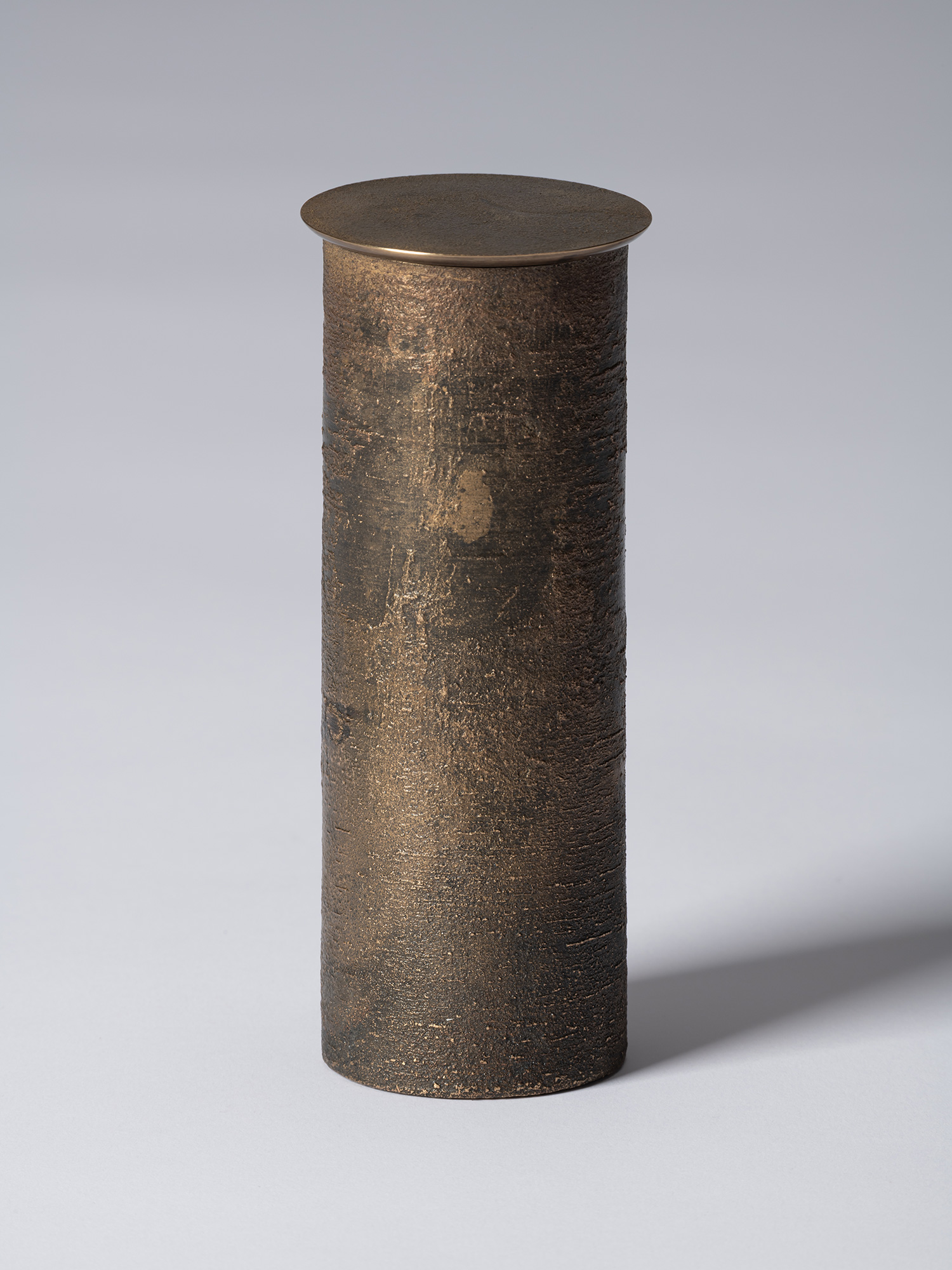 bronze as Bronze II No. 19 by Koji Hatakeyama, a tall cylindrical bronze vessel with a fitted circular...
