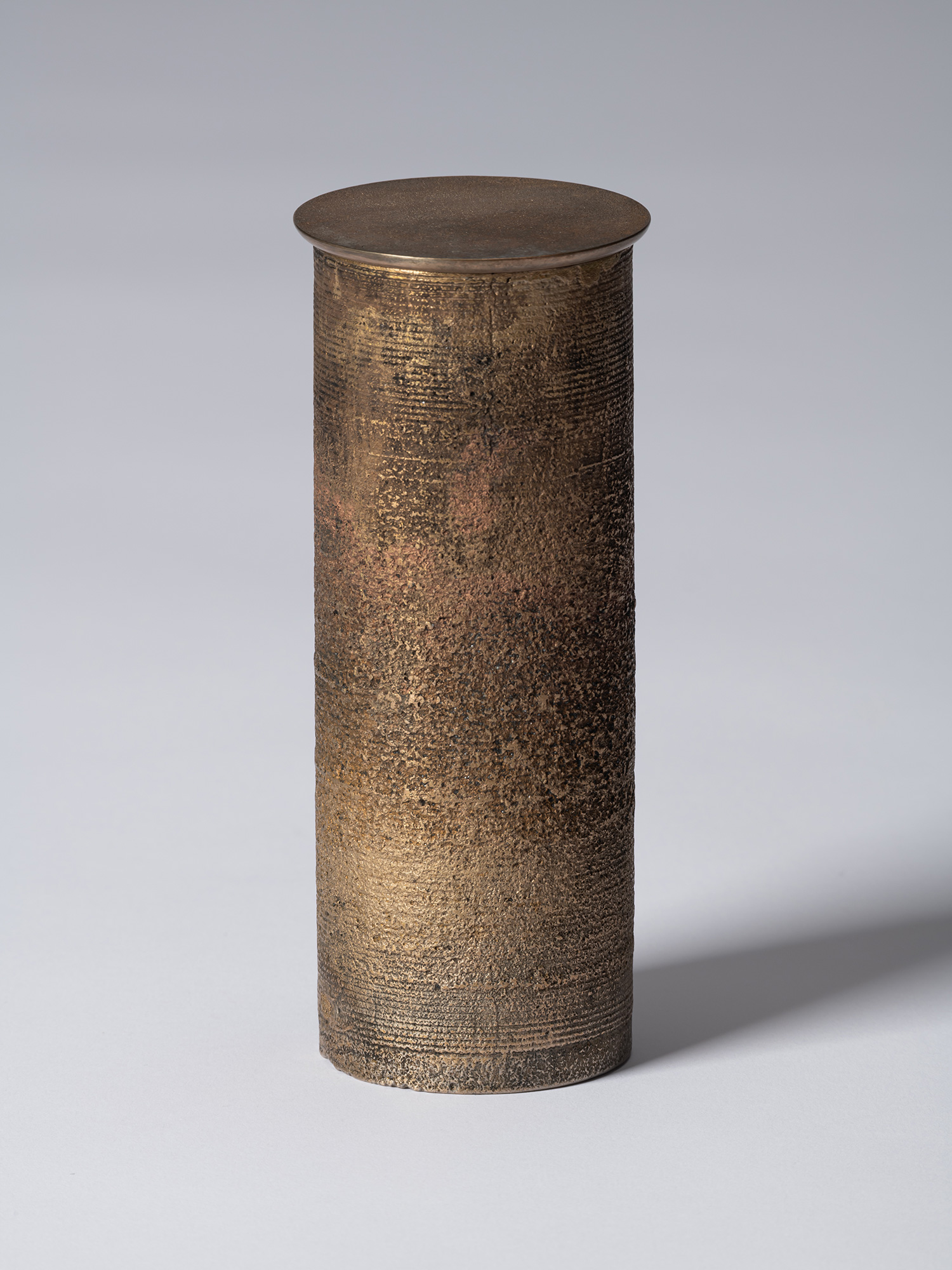 bronze as Bronze II No. 20 by Koji Hatakeyama, a tall cylindrical bronze vessel with a fitted circular...