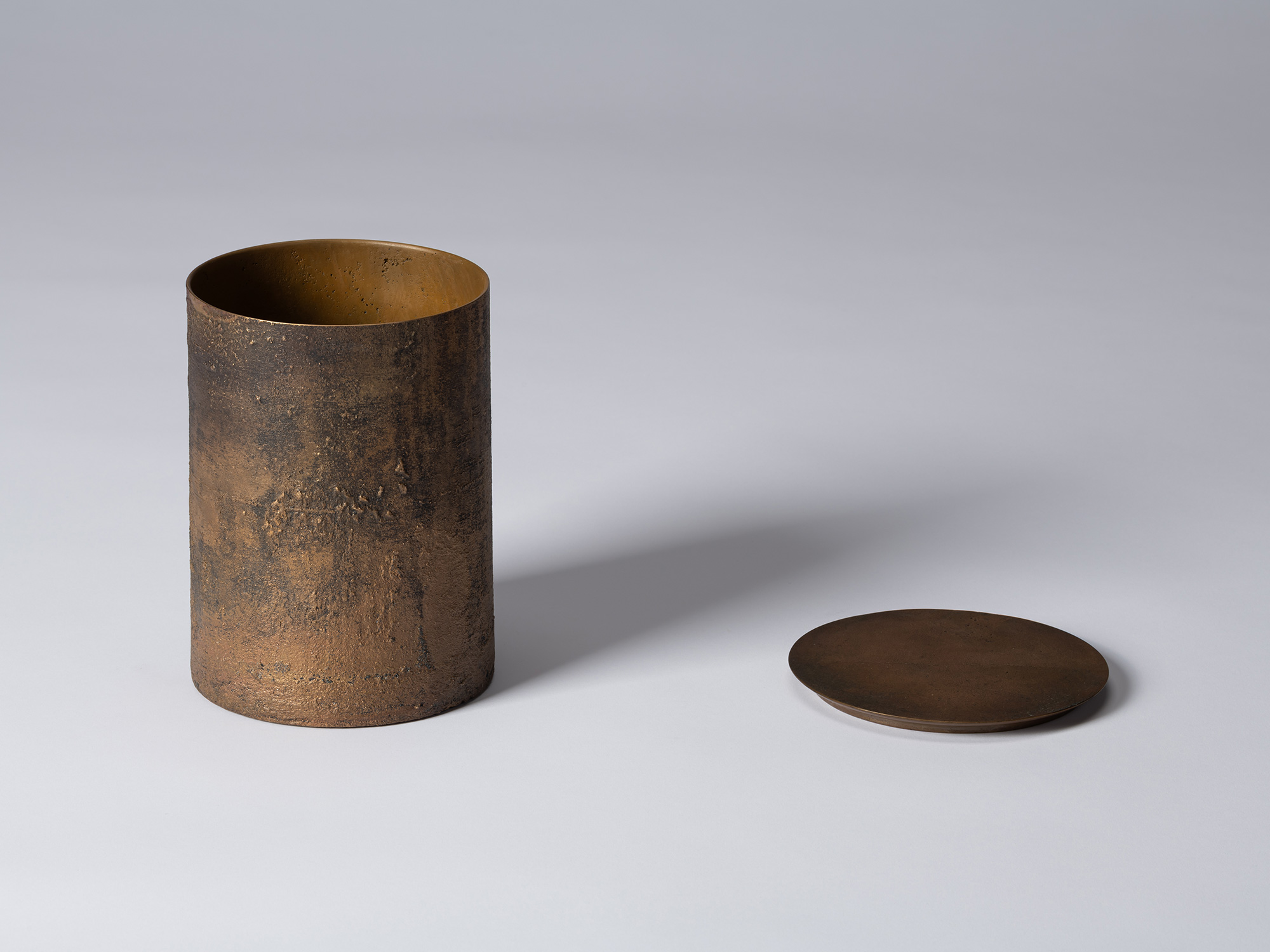 Koji Hatakeyama’s bronze as Bronze II No. 23 shown with its circular lid removed, revealing the...