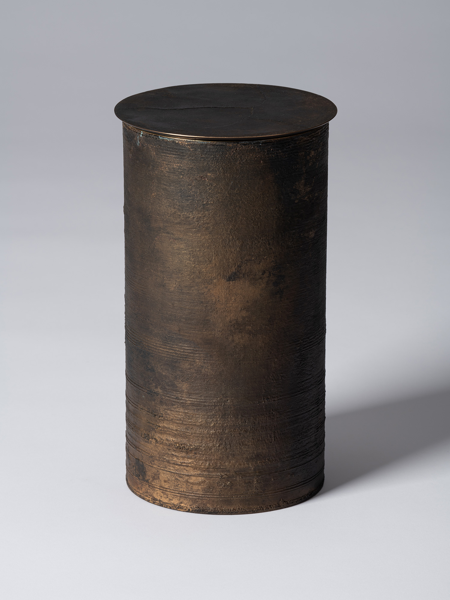 View of Koji Hatakeyama’s bronze as Bronze II No. 25, a tall cylindrical bronze vessel with a flat...