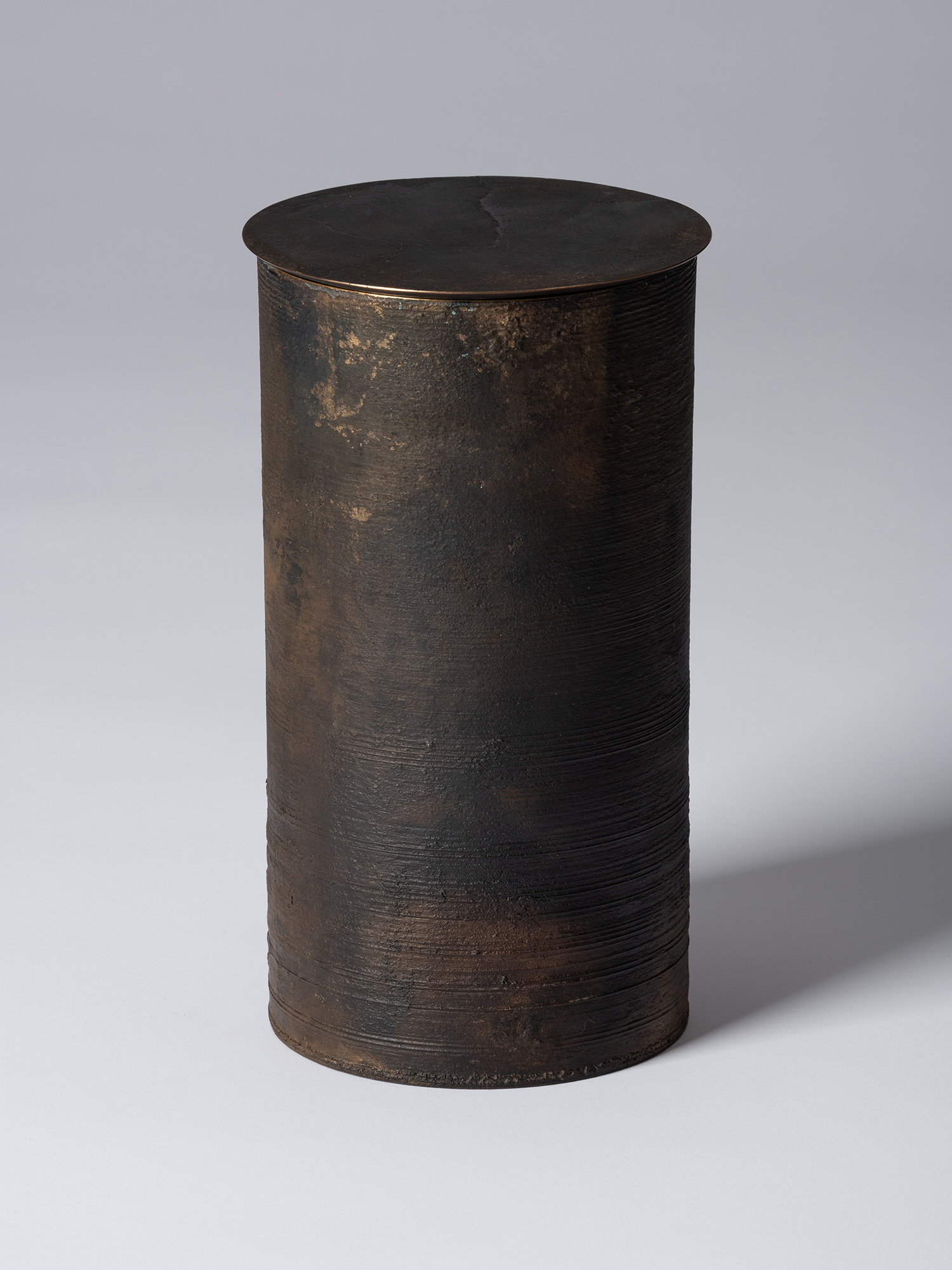 View of Koji Hatakeyama’s bronze as Bronze II No. 25, a tall cylindrical bronze vessel with a flat...