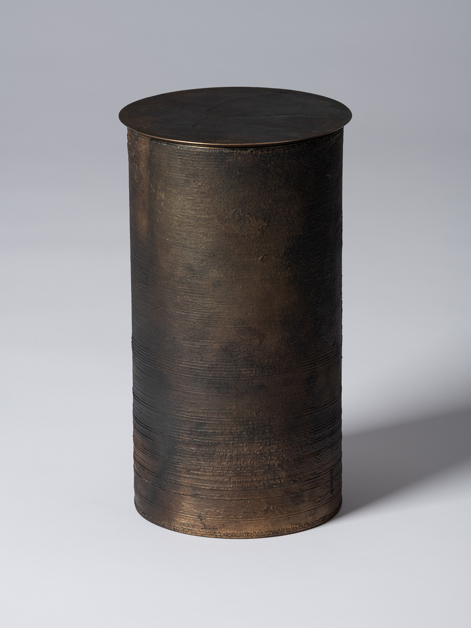 View of Koji Hatakeyama’s bronze as Bronze II No. 25, a tall cylindrical bronze vessel with a flat...
