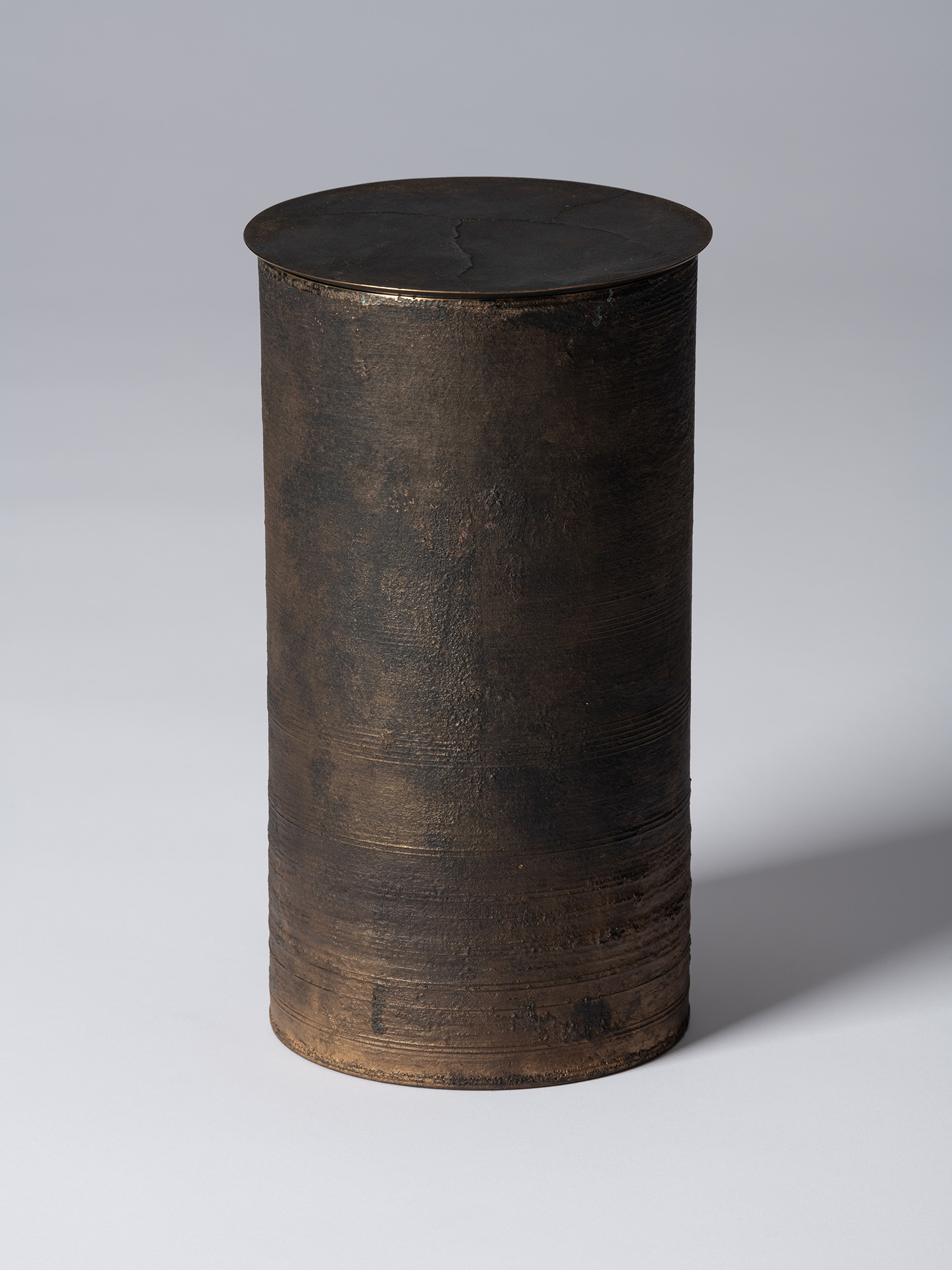 View of Koji Hatakeyama’s bronze as Bronze II No. 25, a tall cylindrical bronze vessel with a flat...