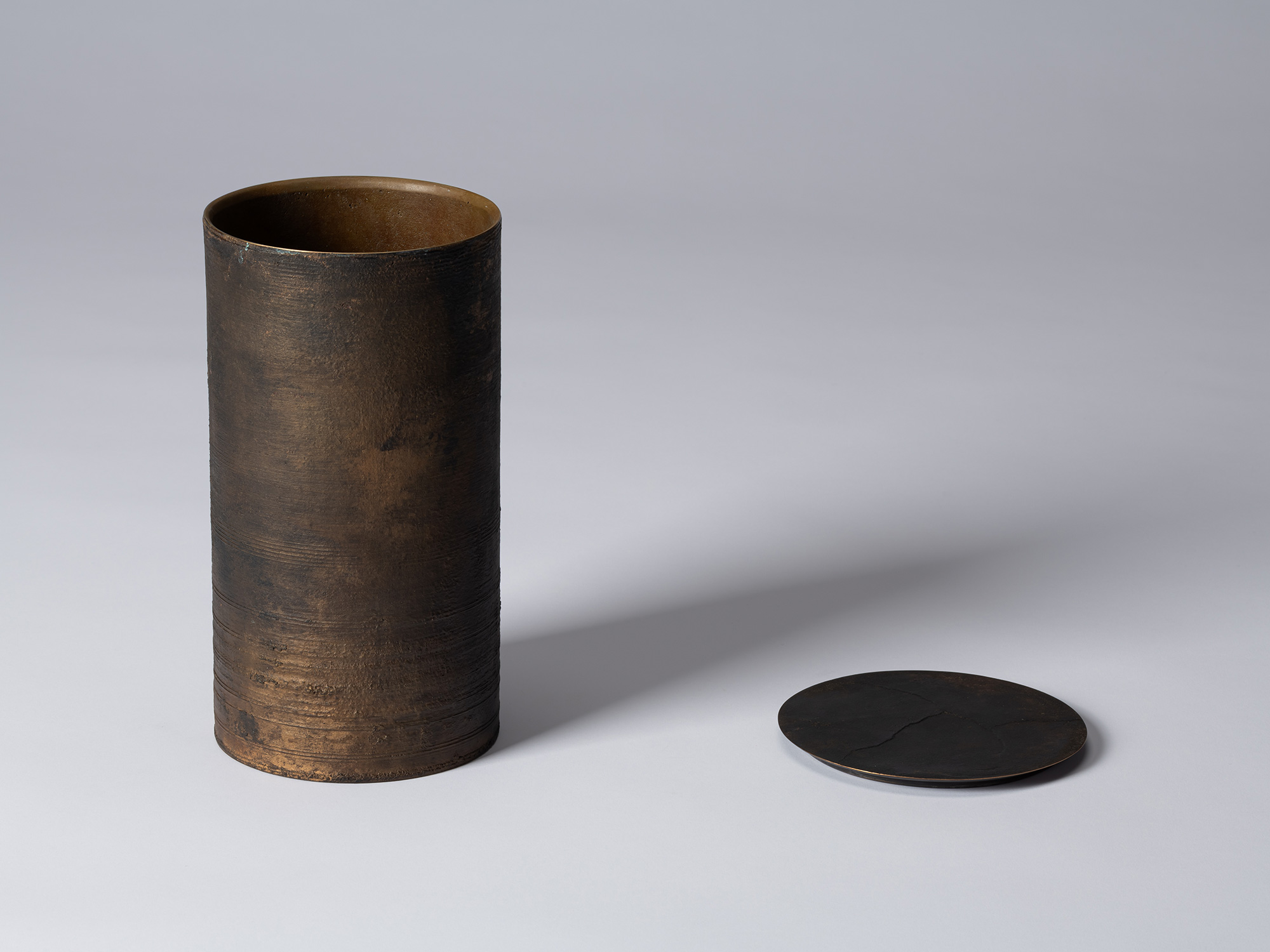 Koji Hatakeyama’s bronze as Bronze II No. 25 shown with its circular lid removed, revealing the...