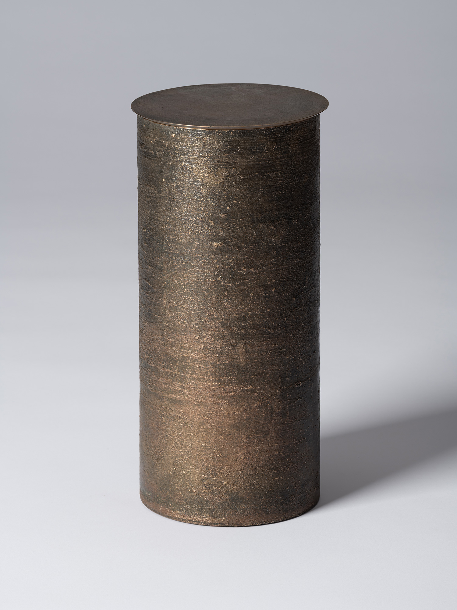 Bronze as Bronze II No. 27 by Koji Hatakeyama, a tall cylindrical lidded vessel with a dark brown...