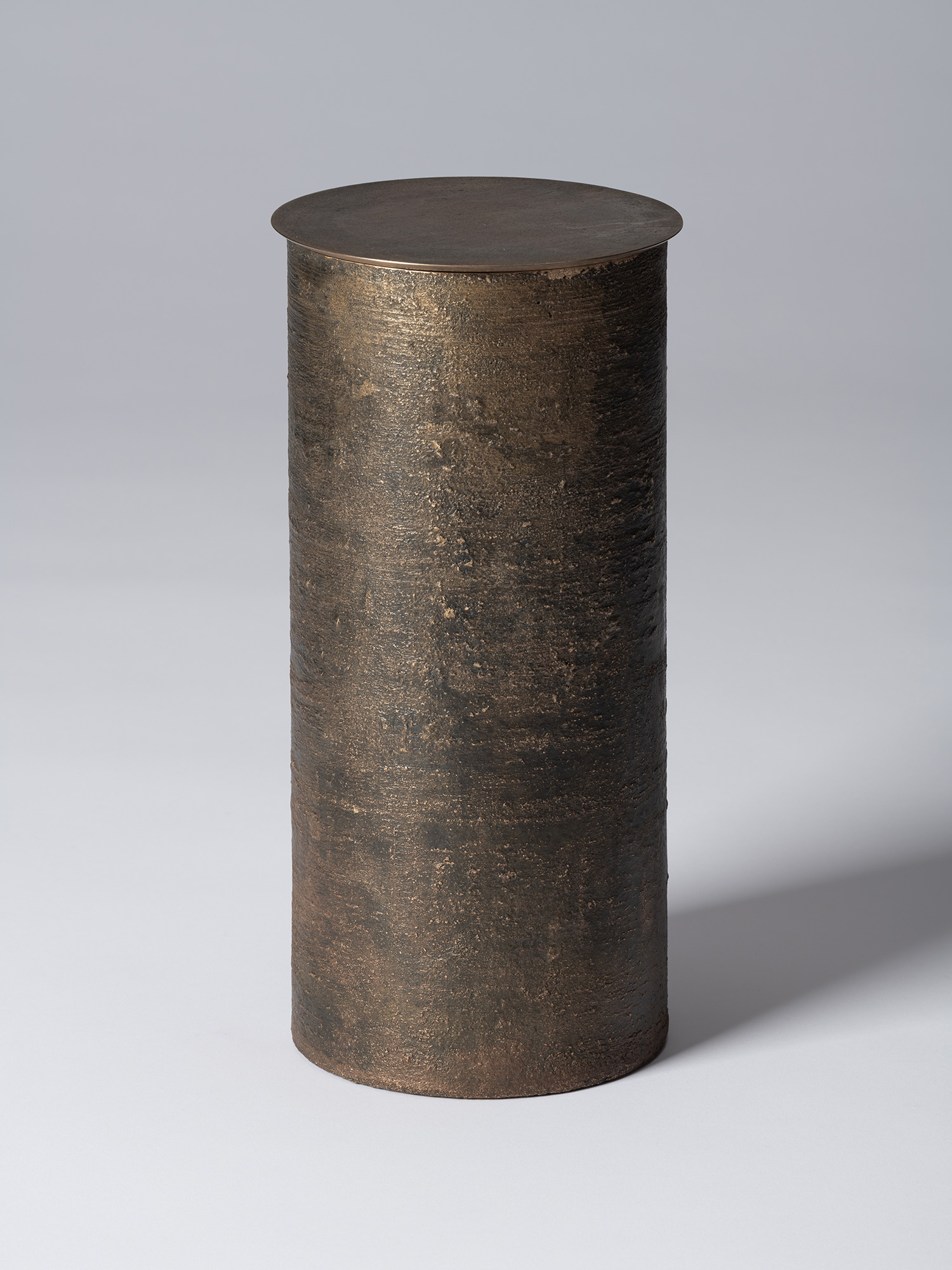 Bronze as Bronze II No. 27 by Koji Hatakeyama, a tall cylindrical lidded vessel with a dark brown...