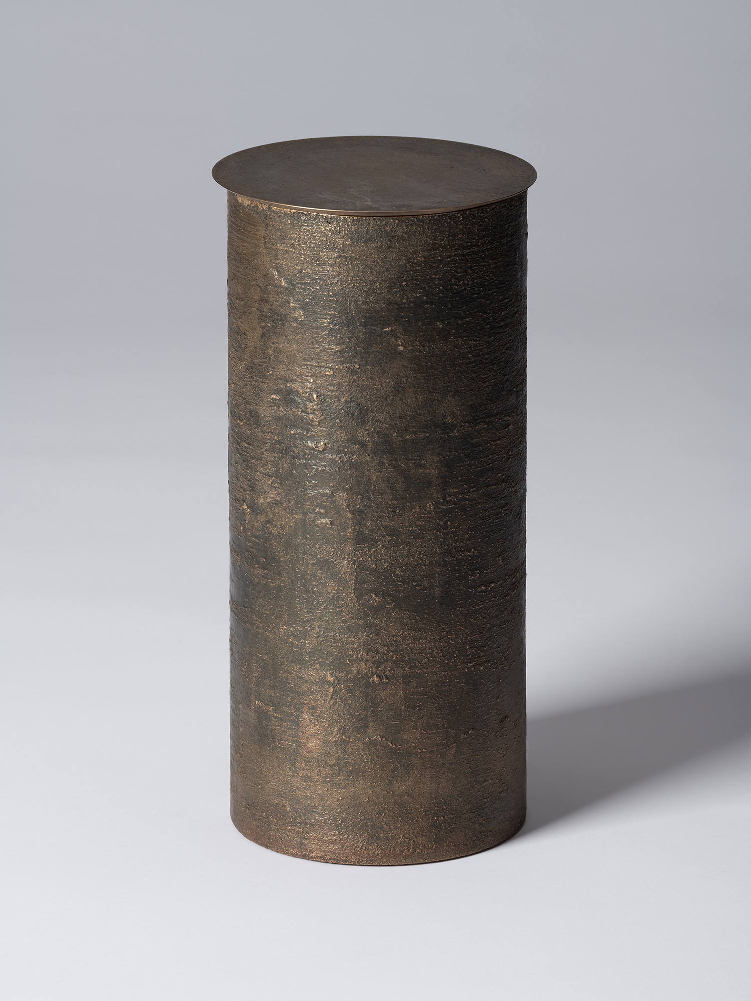 Bronze as Bronze II No. 27 by Koji Hatakeyama, a tall cylindrical lidded vessel with a dark brown...