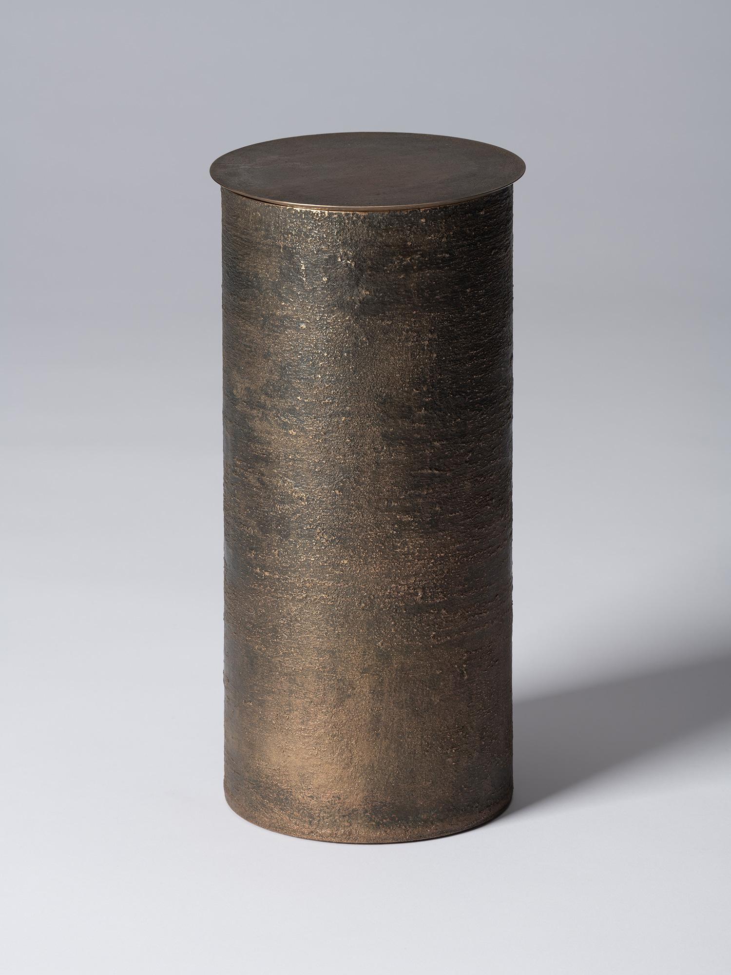 Bronze as Bronze II No. 27 by Koji Hatakeyama, a tall cylindrical lidded vessel with a dark brown...
