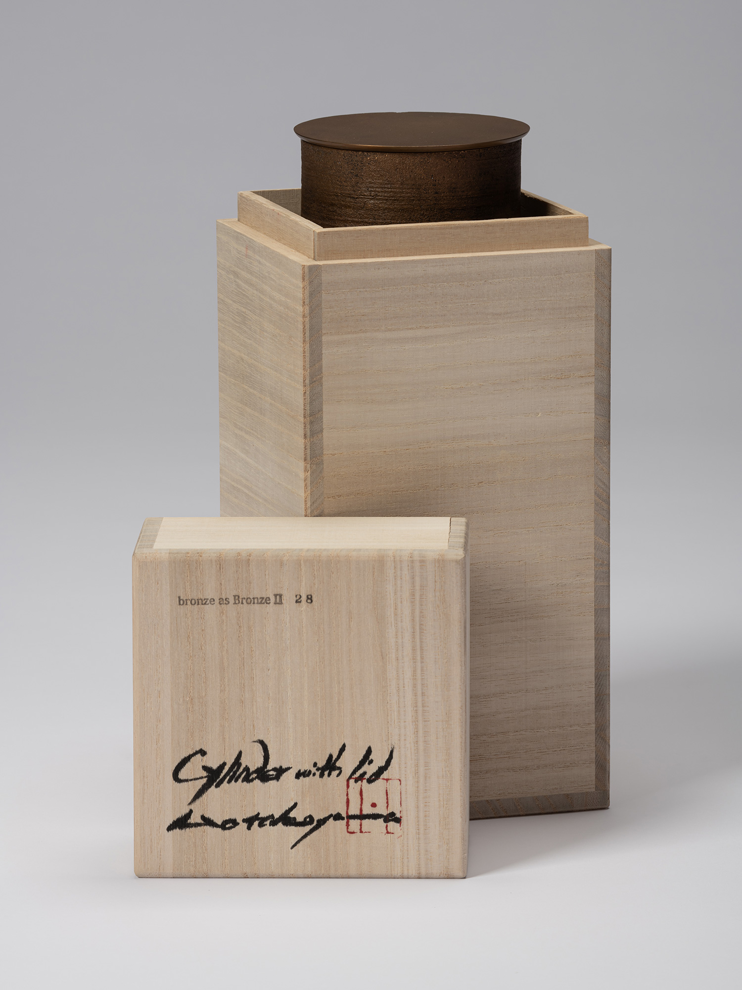 Bronze as Bronze II No. 28 partially enclosed in its open tomobako, with the inscribed wooden lid...