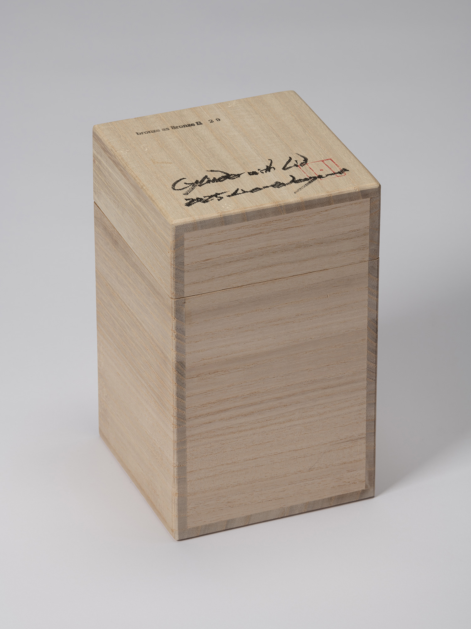 Closed wooden storage box for bronze as Bronze II No. 29, with the title and handwritten inscriptions...
