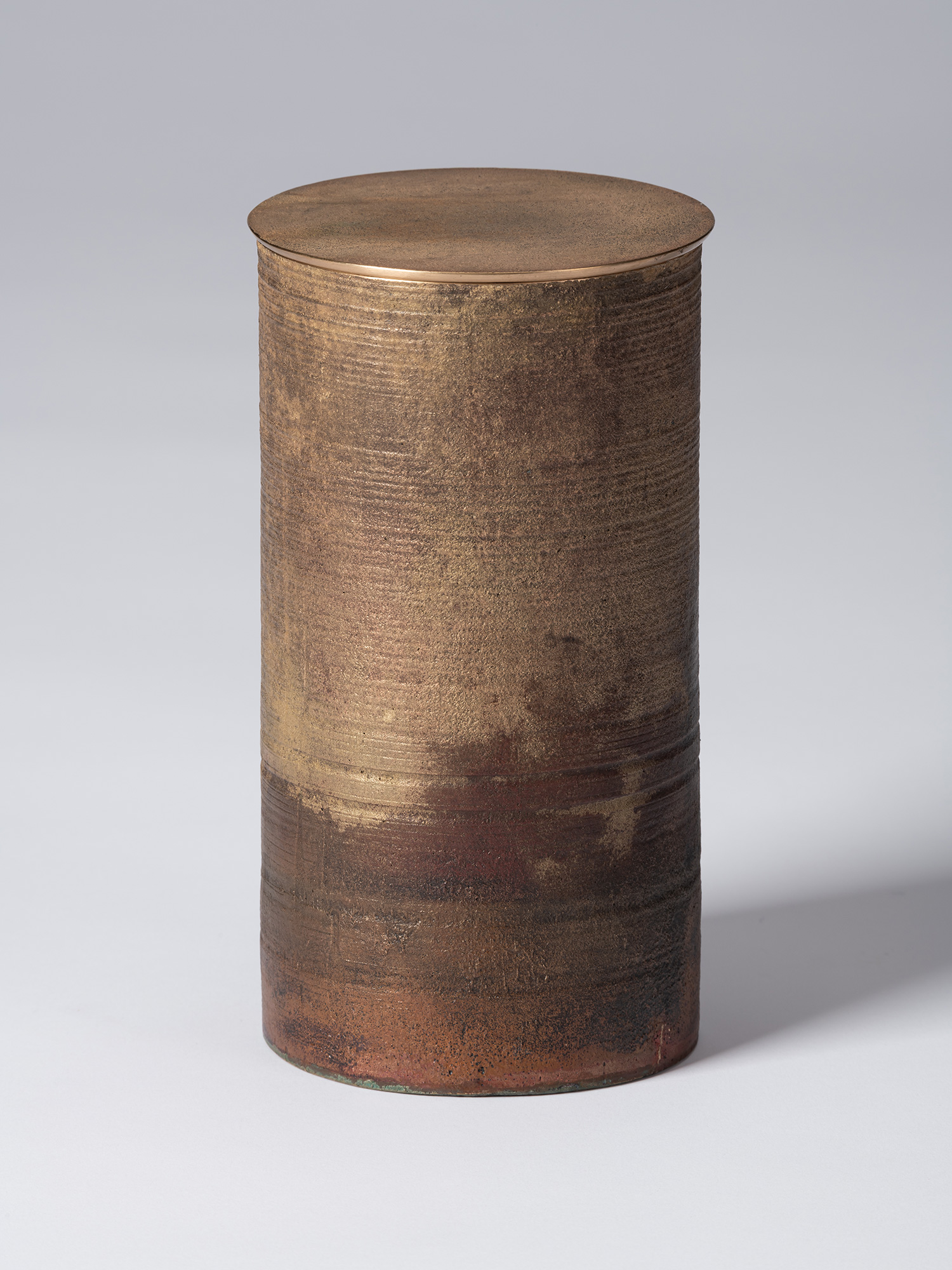 Front view of Koji Hatakeyama’s bronze as Bronze II No. 29, a tall cylindrical bronze vessel with...