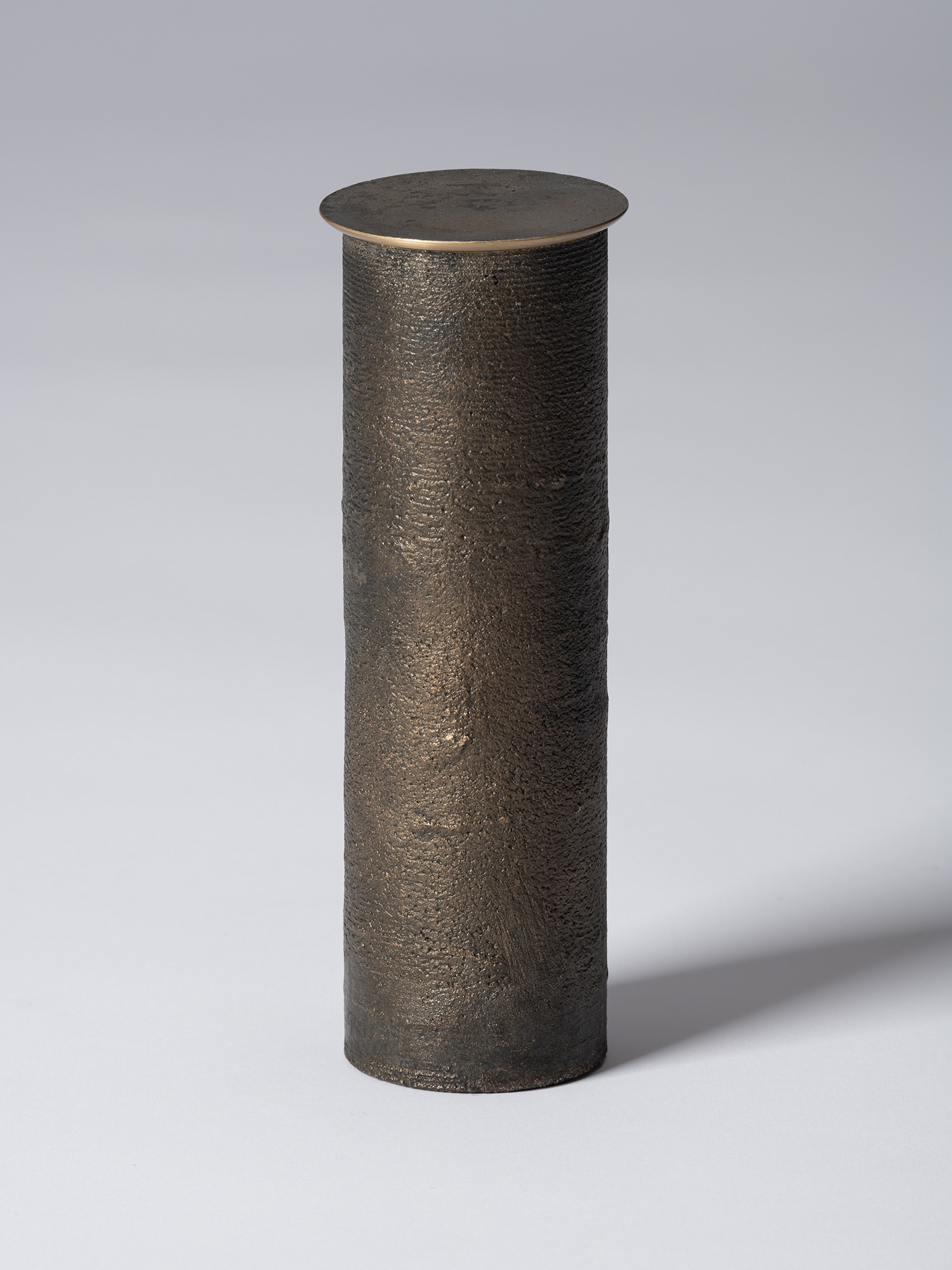 Front view of bronze as Bronze II No. 31 by Koji Hatakeyama, a tall cylindrical bronze vessel with...